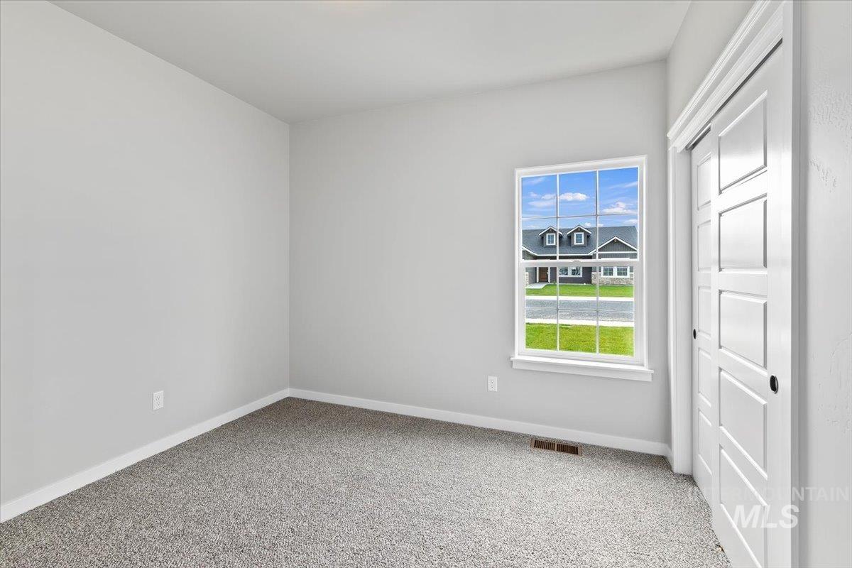 Unfurnished bedroom featuring light colored carpet and a closet