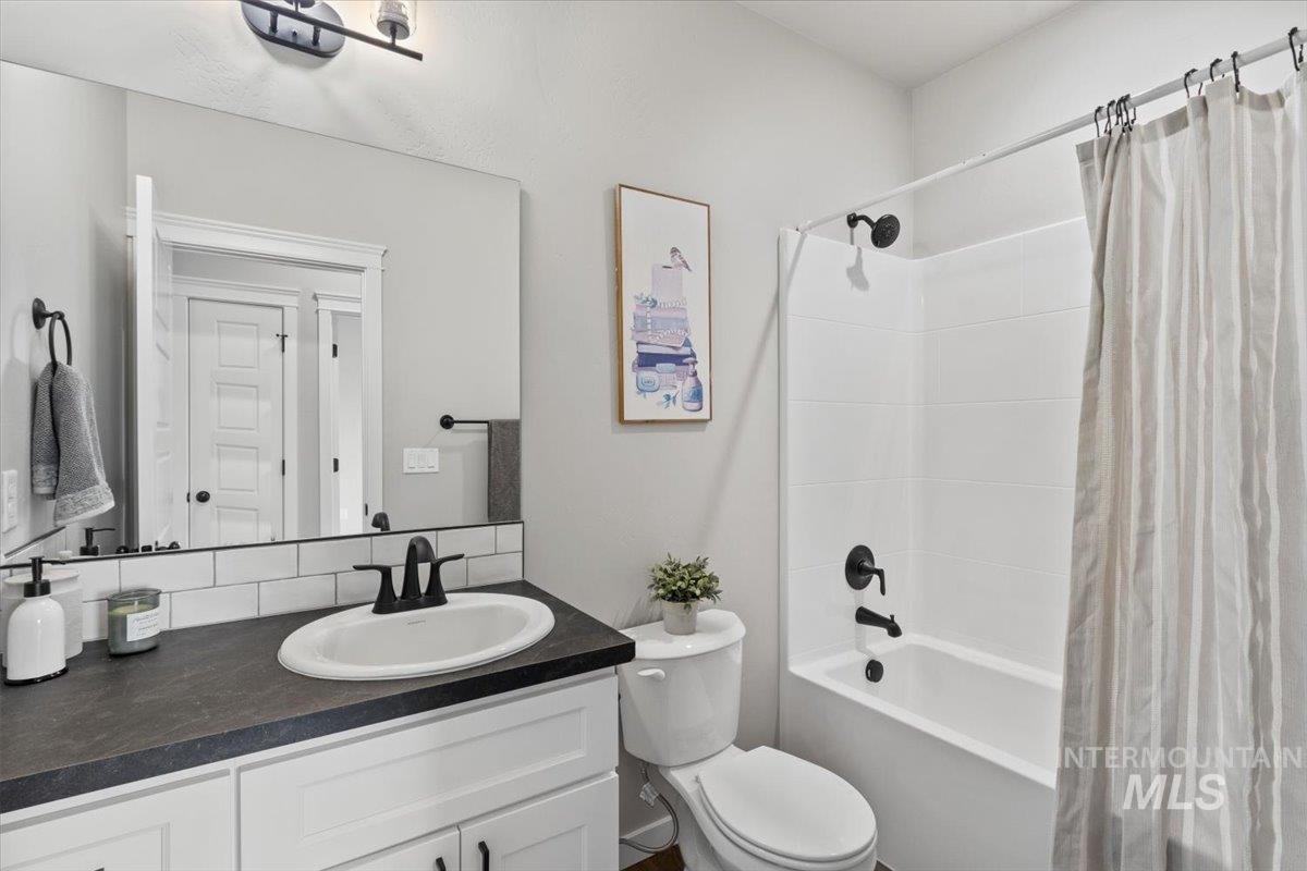 Bathroom with shower / bath combo and vanity