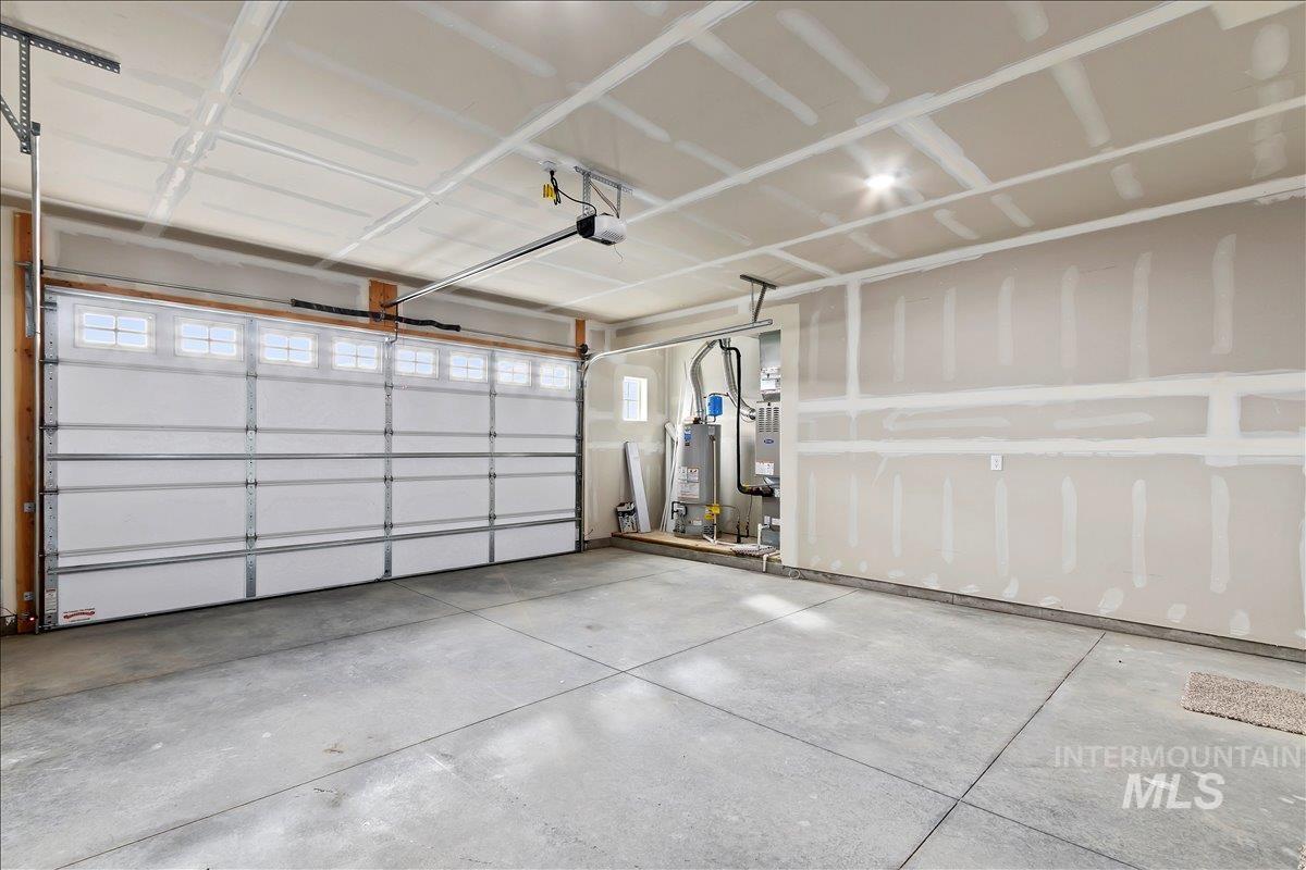 Garage with water heater and a garage door opener
