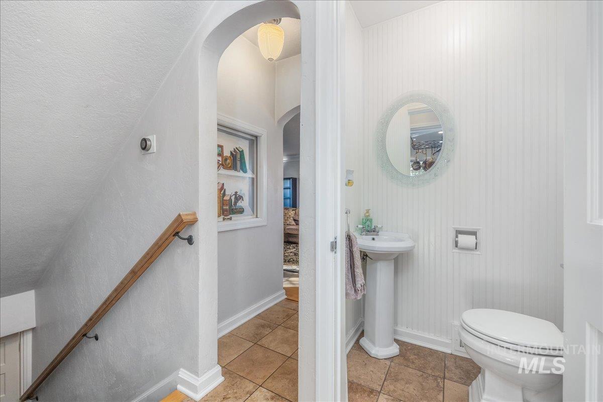Bathroom with light tile patterned flooring and toilet