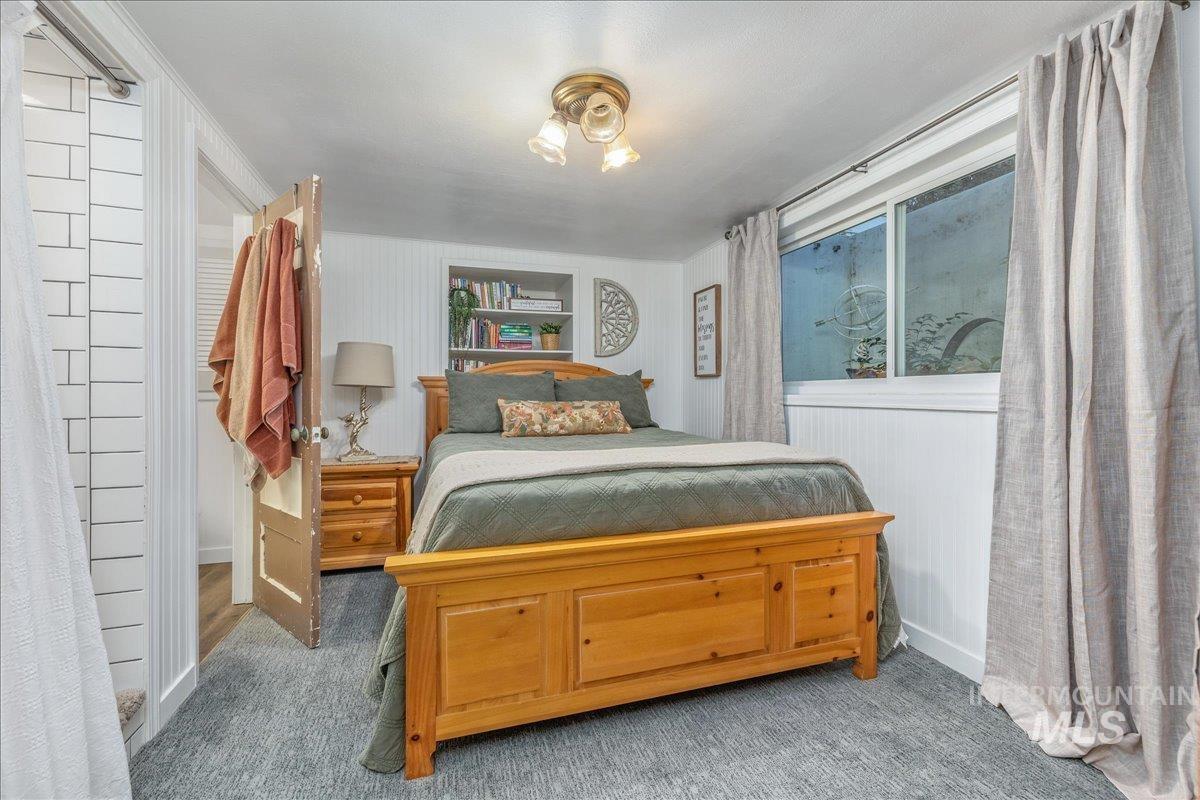 Carpeted bedroom featuring baseboards