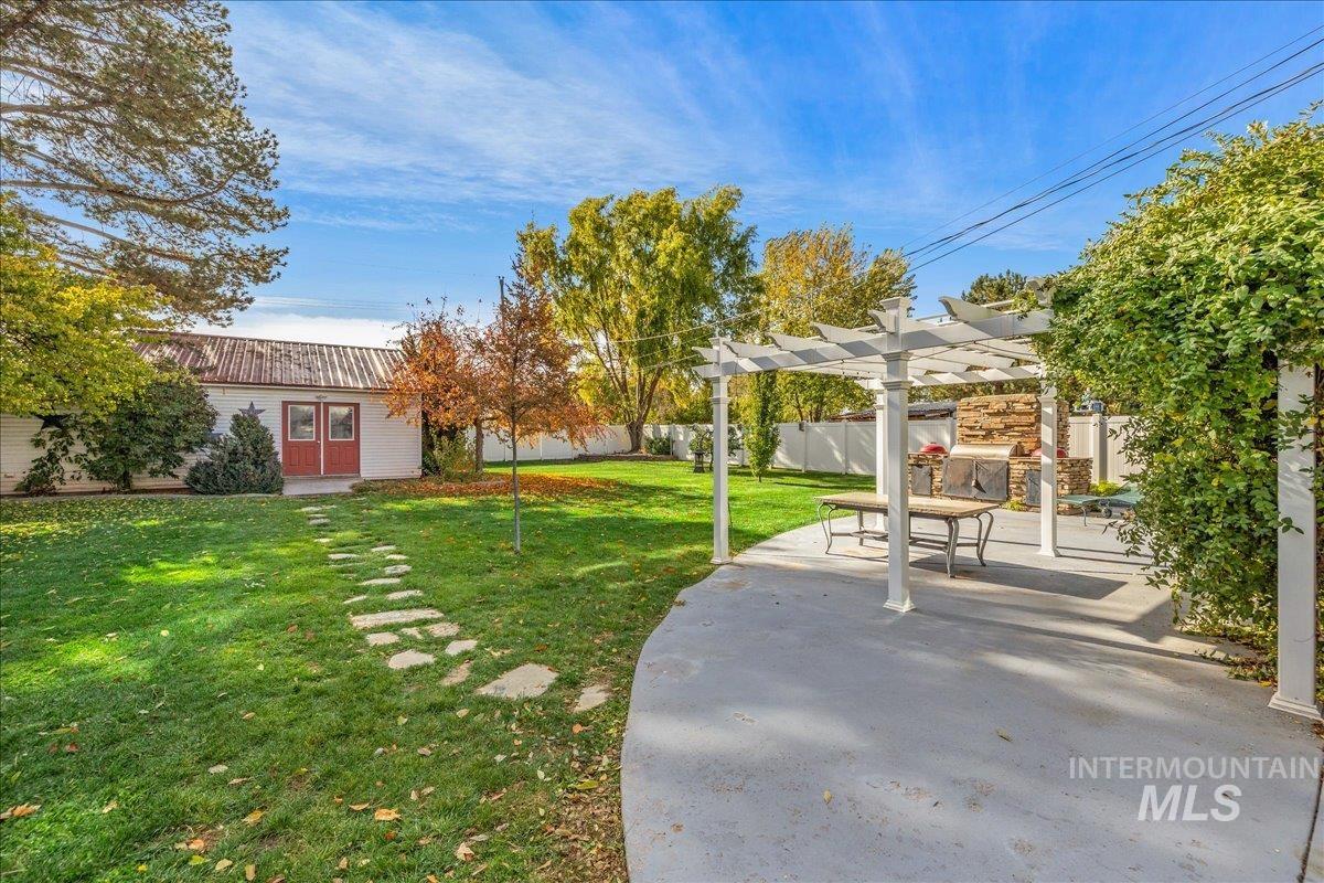 View of yard featuring a pergola and a patio
