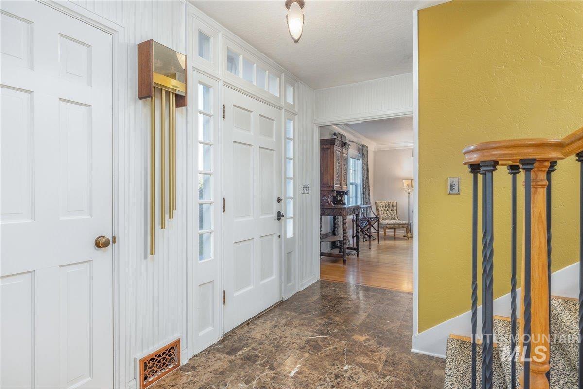 Foyer with stairway and ornamental molding