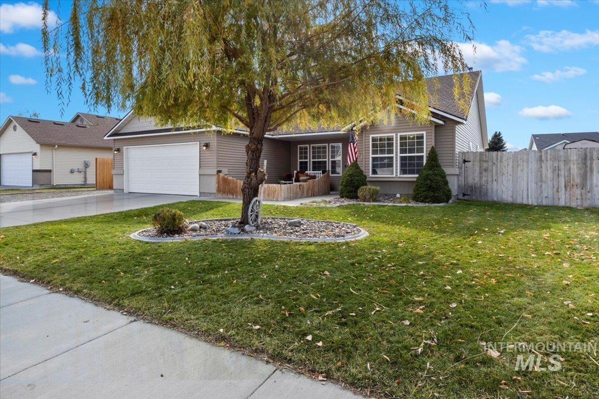 Ranch-style house with concrete driveway and a garage