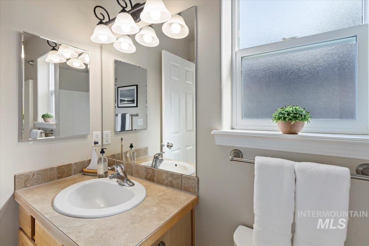 Bathroom featuring vanity and a chandelier