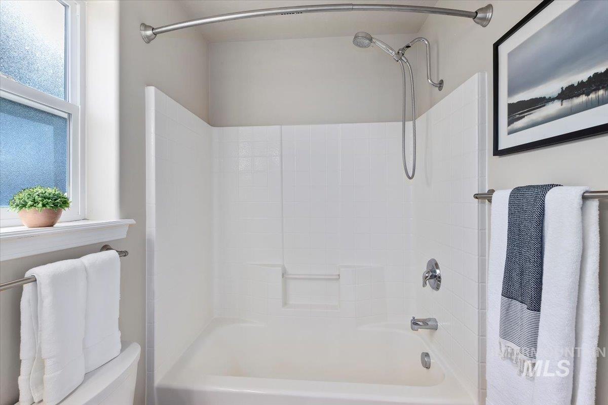 Full bathroom featuring shower / washtub combination and toilet
