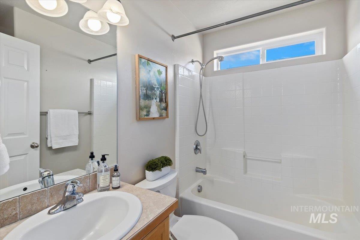 Bathroom featuring vanity and  shower combination