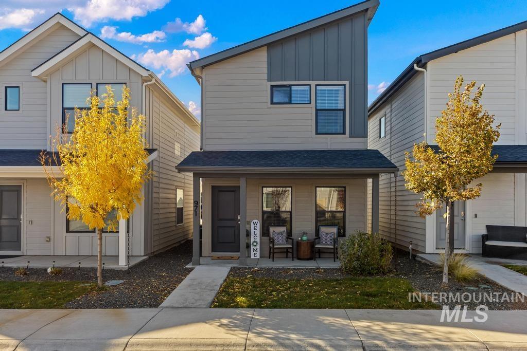 Contemporary home with board and batten siding, covered porch, and a shingled roof