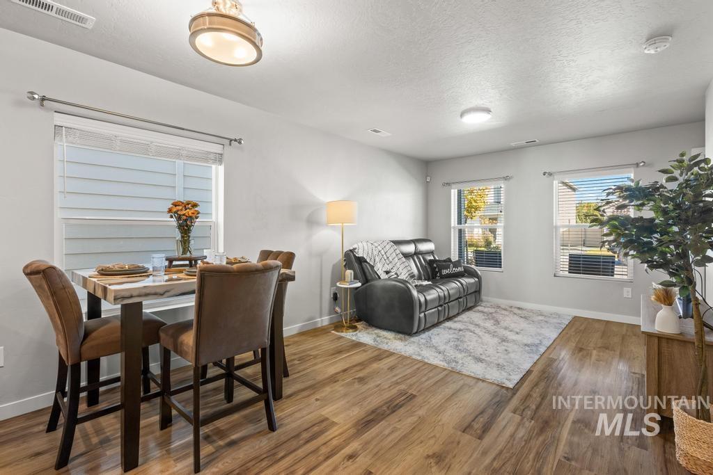 Dining room featuring wood finished floors and a textured ceiling