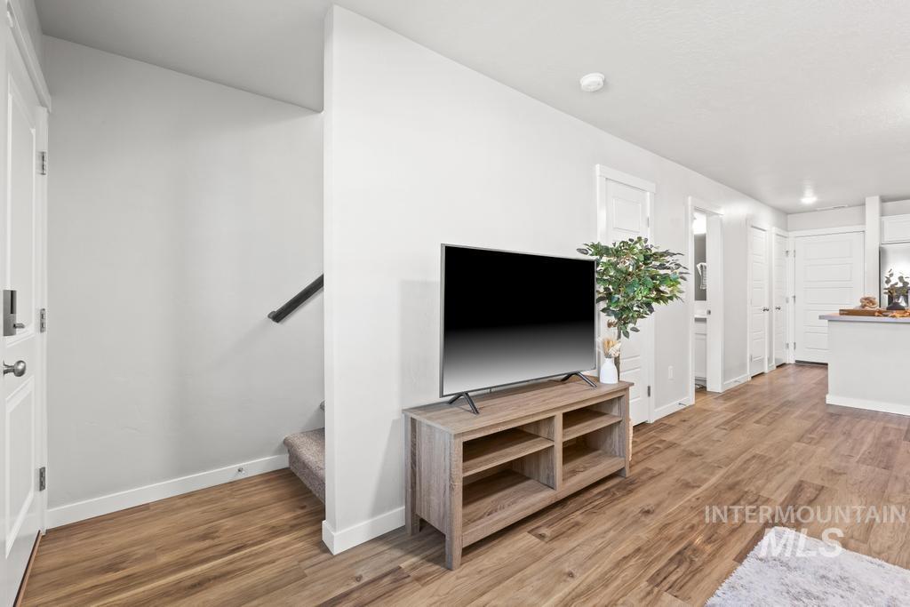 Living area featuring stairs and light wood-type flooring