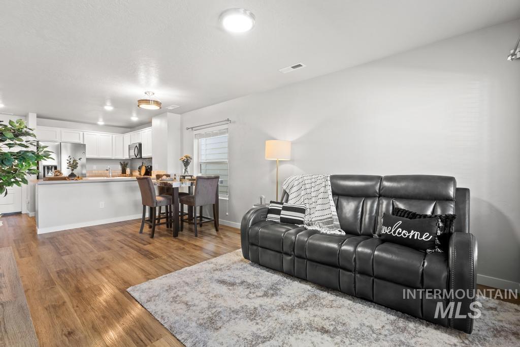 Living area with wood finished floors and baseboards