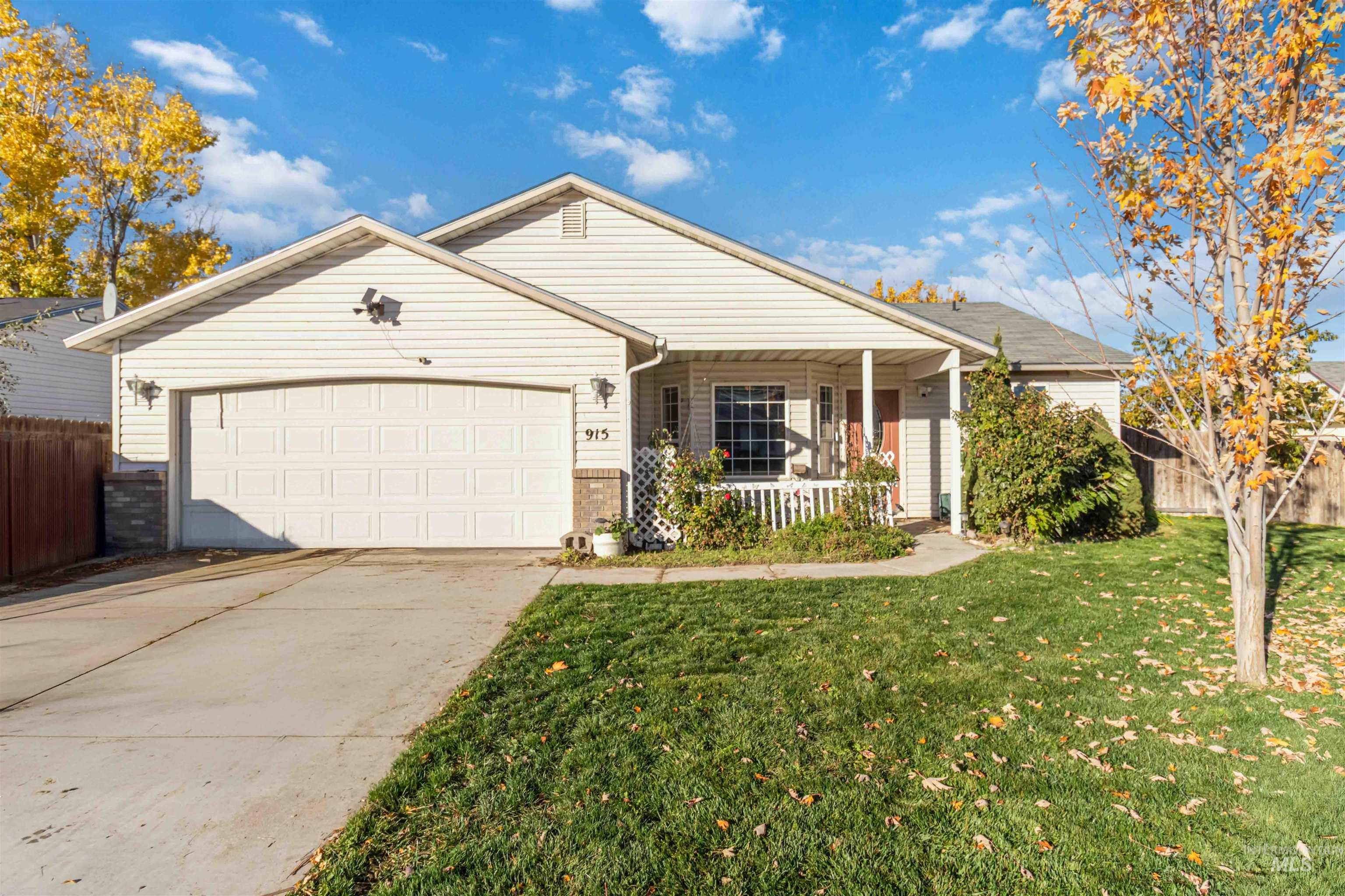Ranch-style house with covered porch, an attached garage, concrete driveway, and brick siding