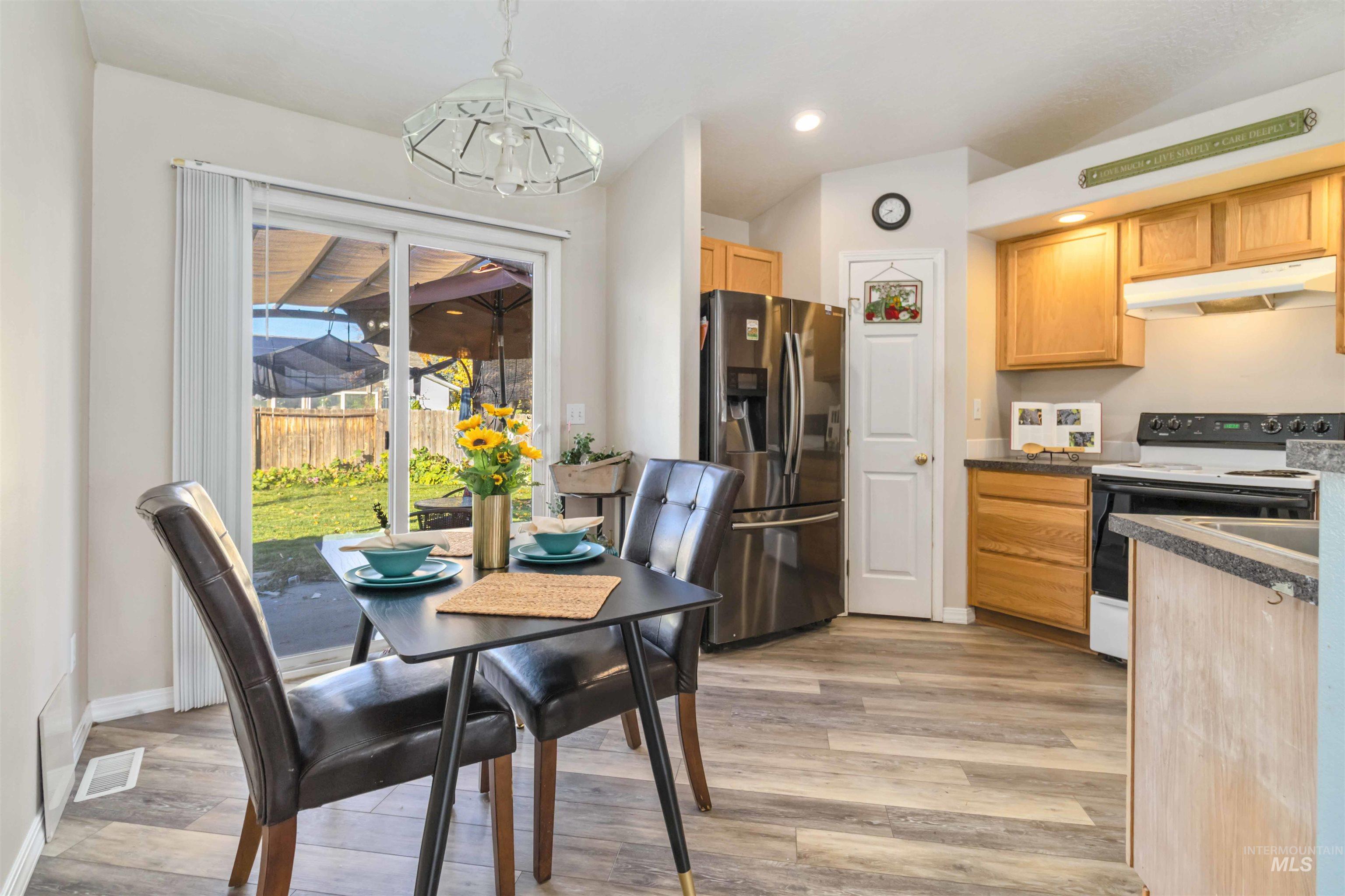 Dining space with recessed lighting, light wood-style floors, and a chandelier