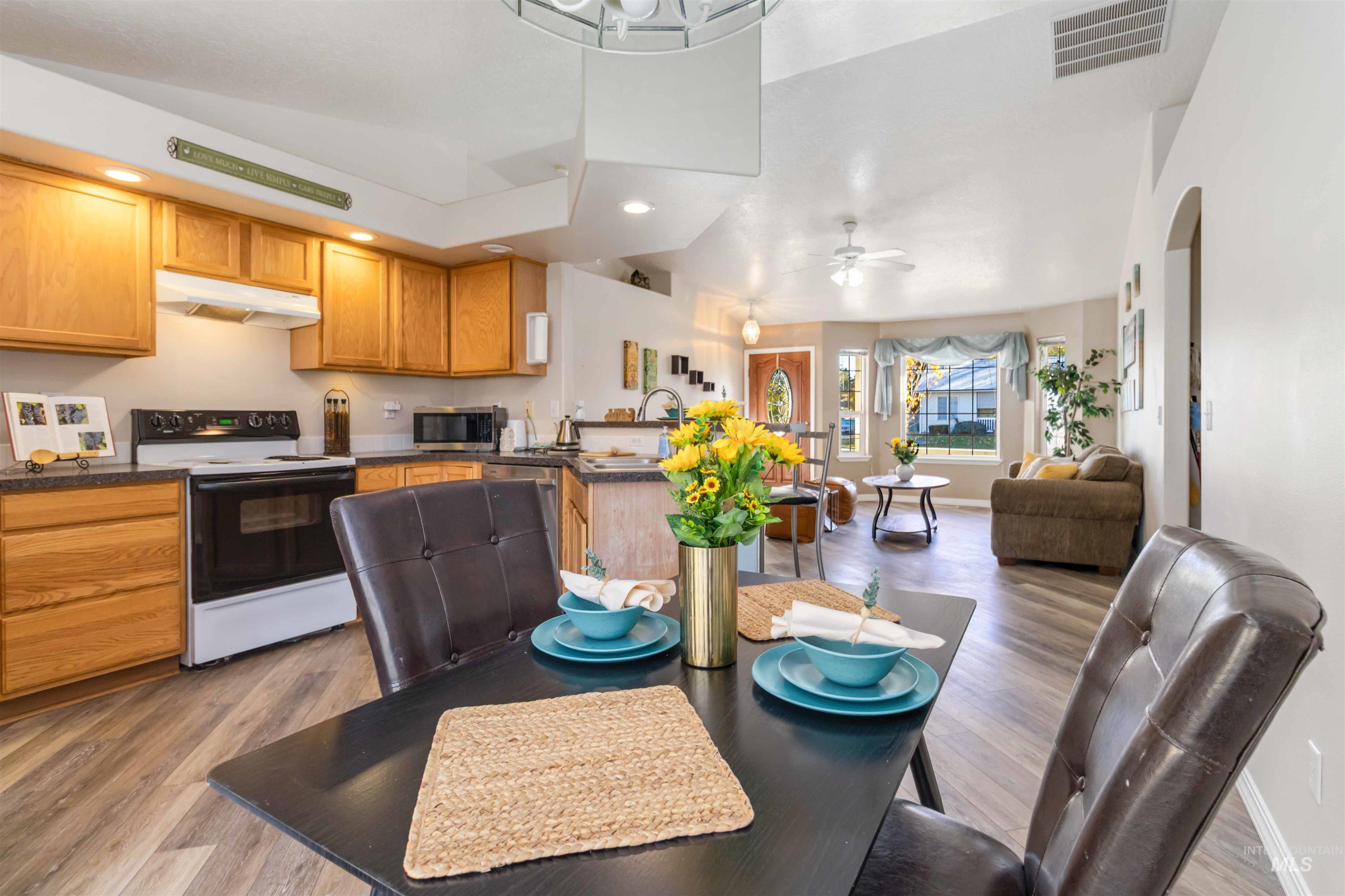 Kitchen featuring stainless steel appliances, recessed lighting, a peninsula, open floor plan, and dark wood-type flooring