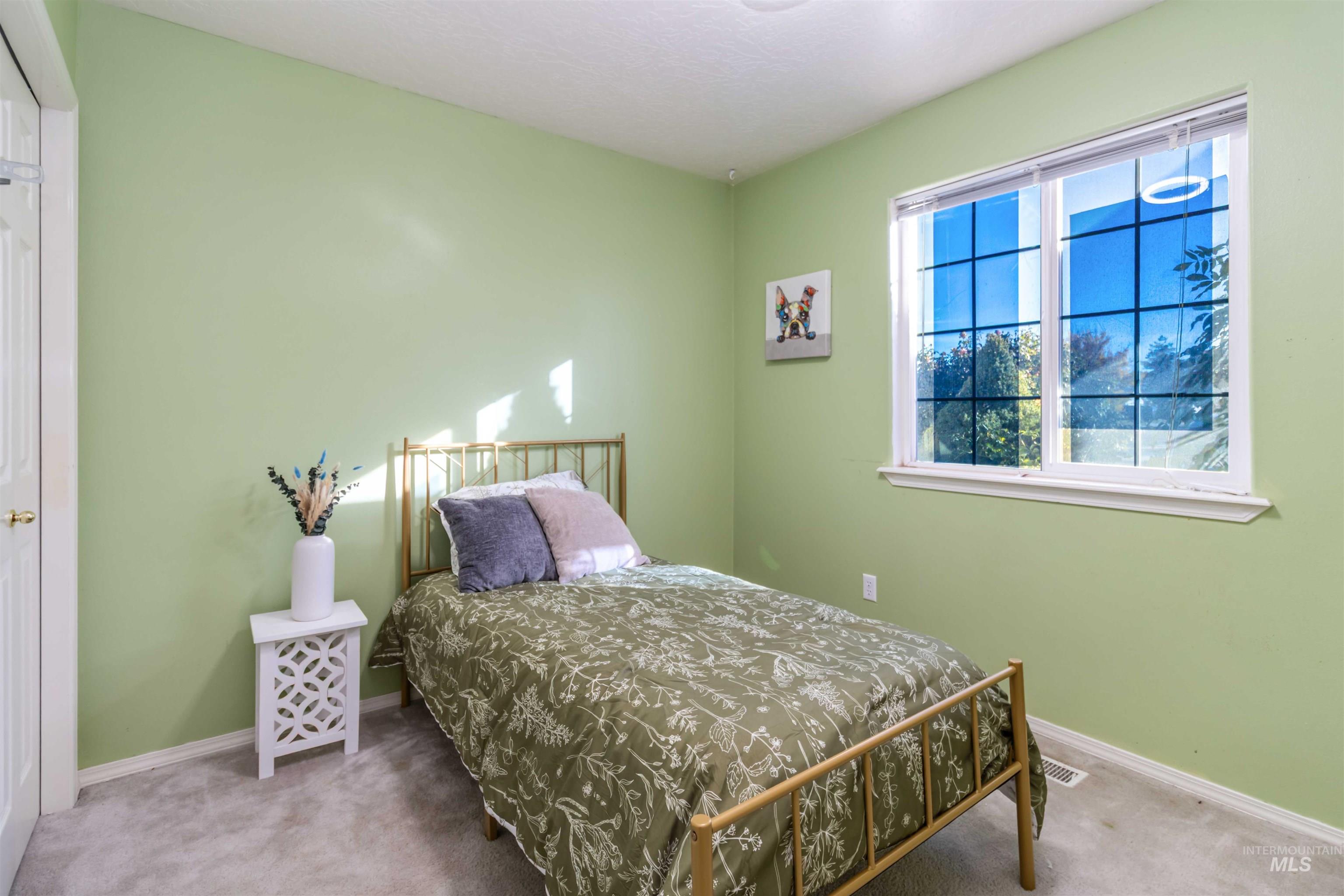 Carpeted bedroom featuring baseboards