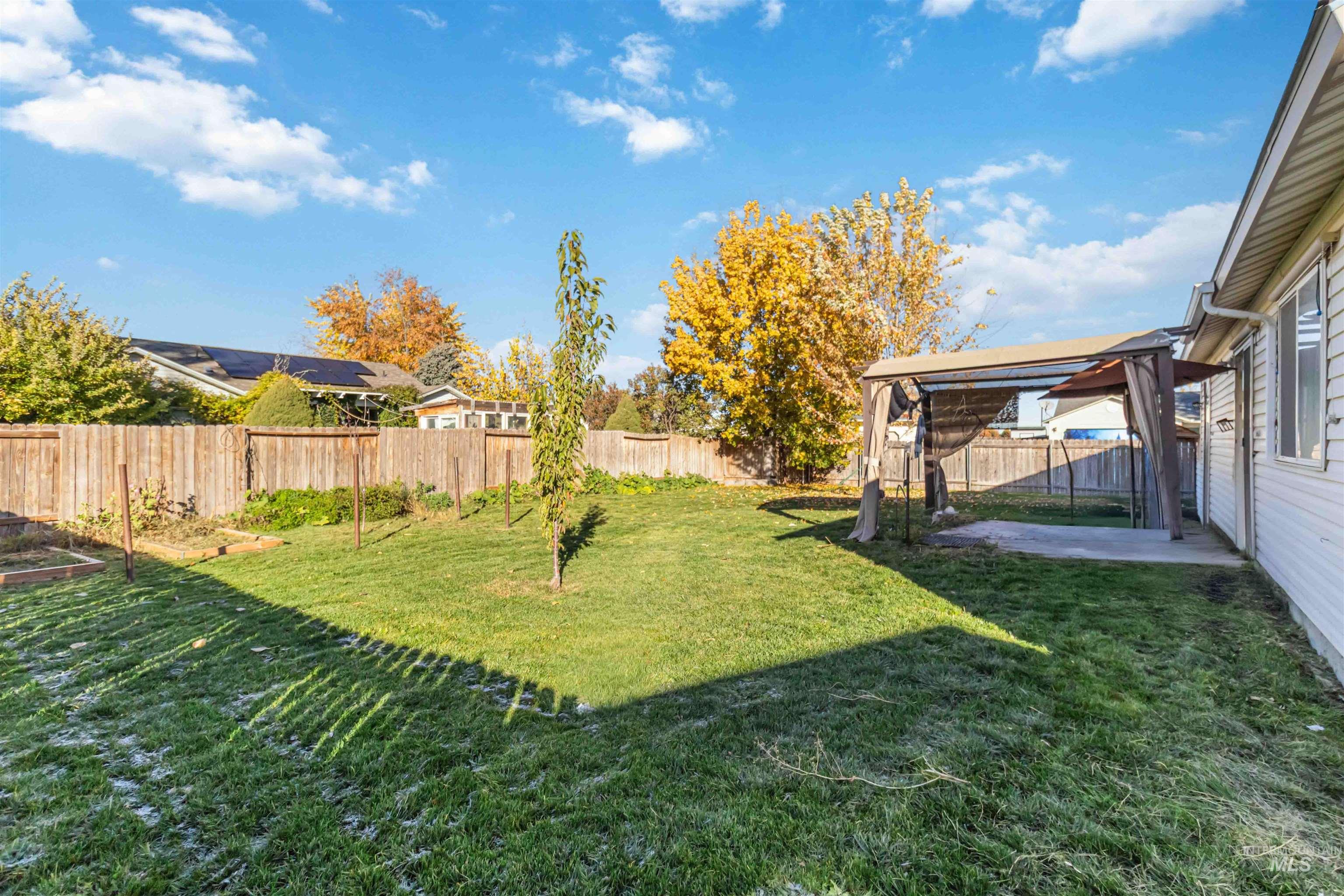 Fenced backyard featuring a patio area and a garden