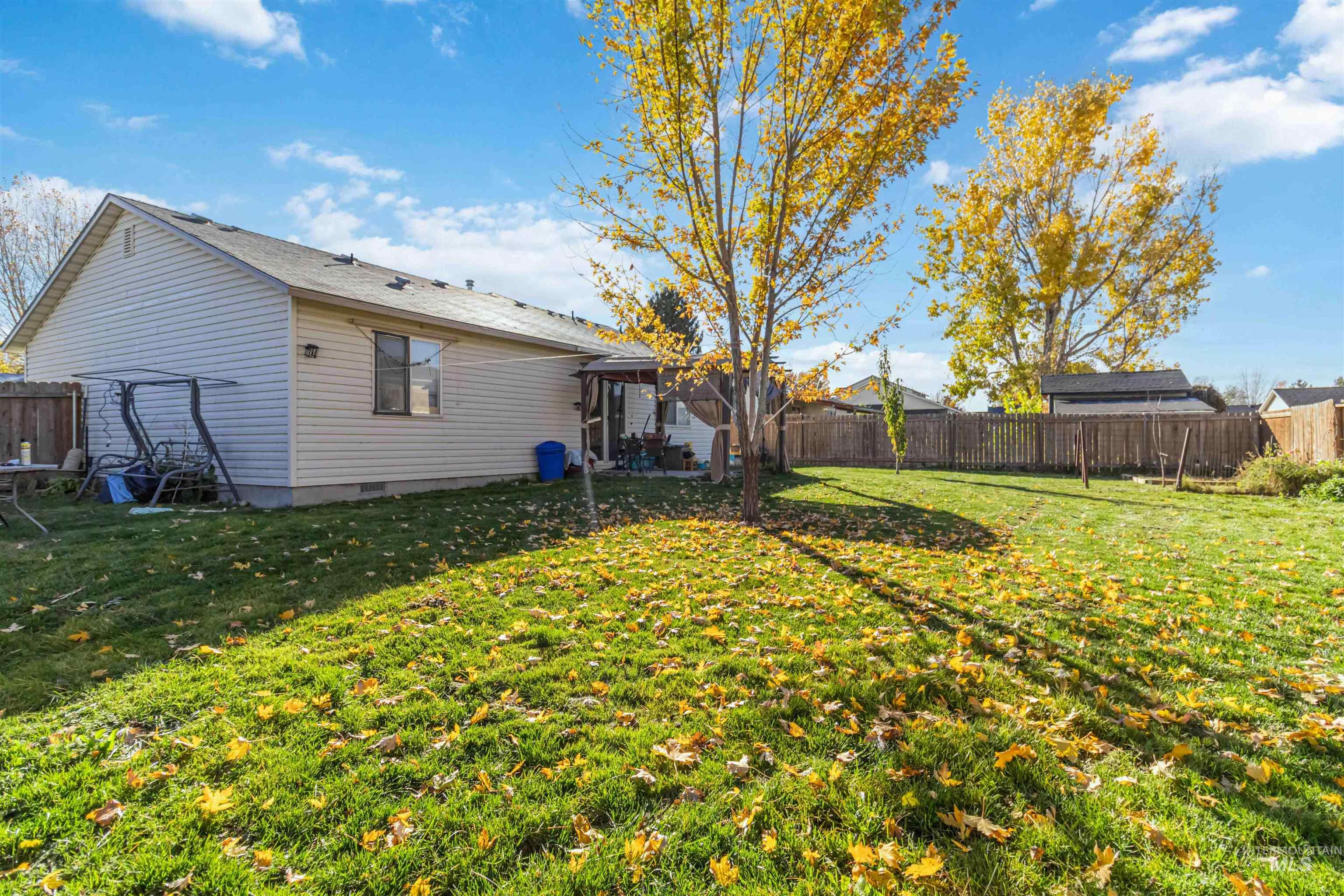 Fenced backyard with a patio area