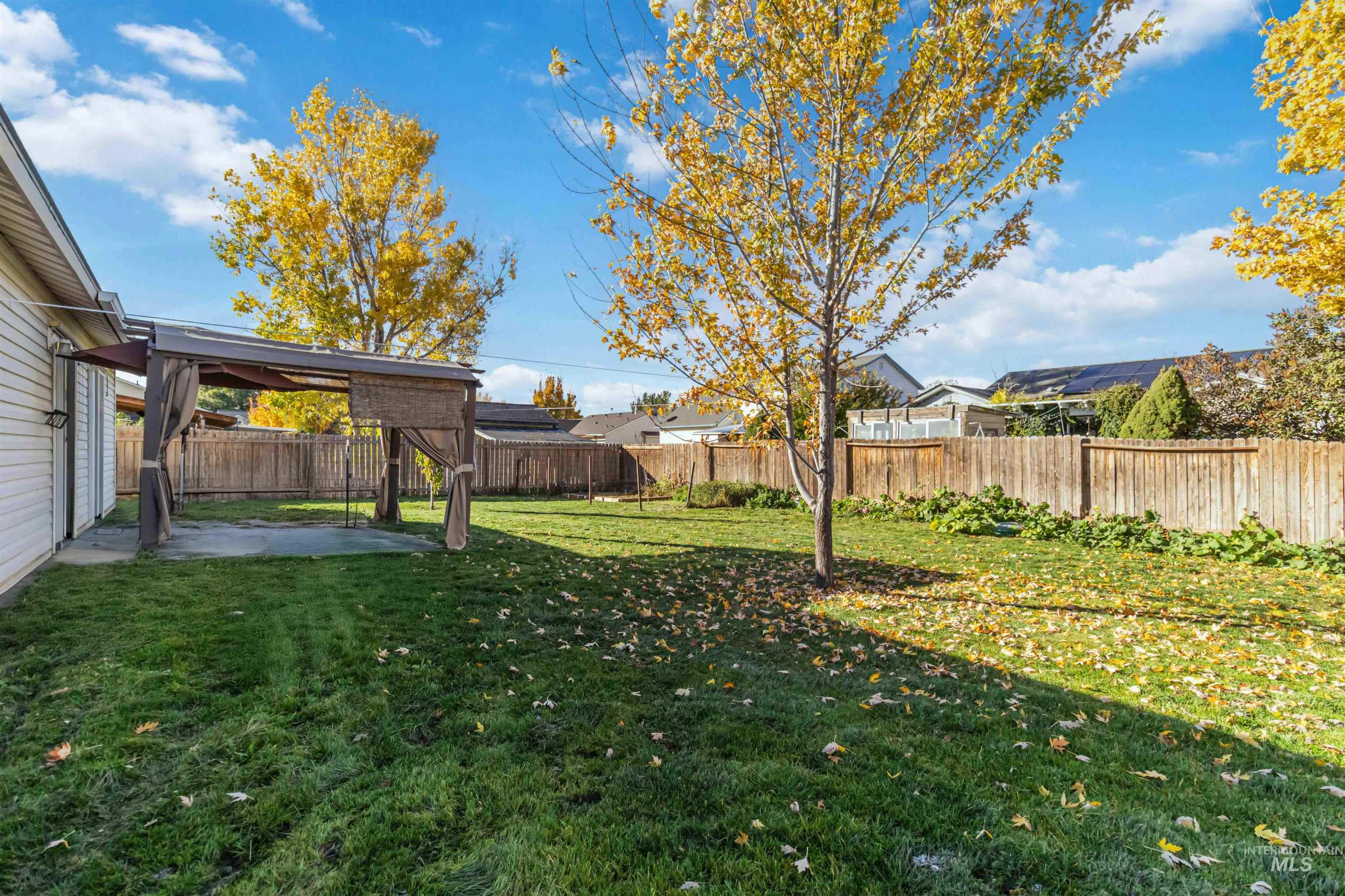 Fenced backyard featuring a patio