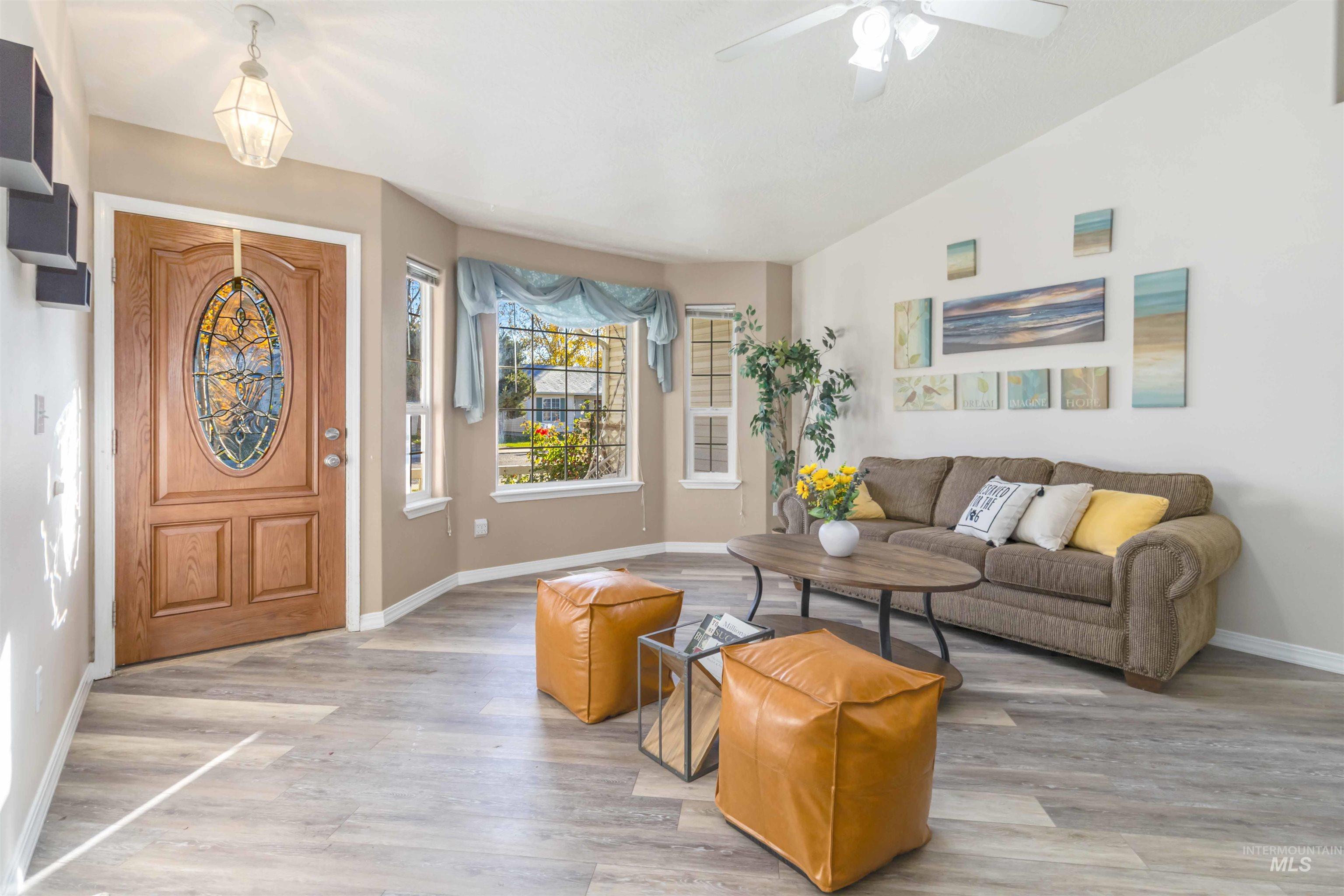 Entrance foyer with lofted ceiling and light wood finished floors