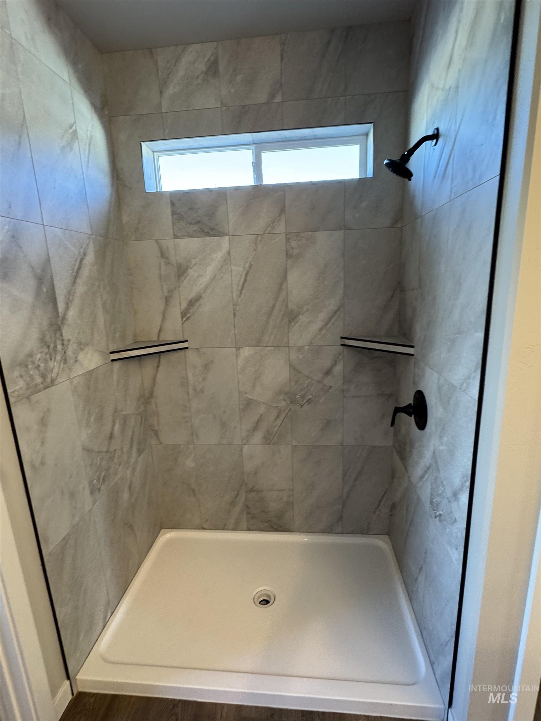 Full bath with a stall shower and healthy amount of natural light