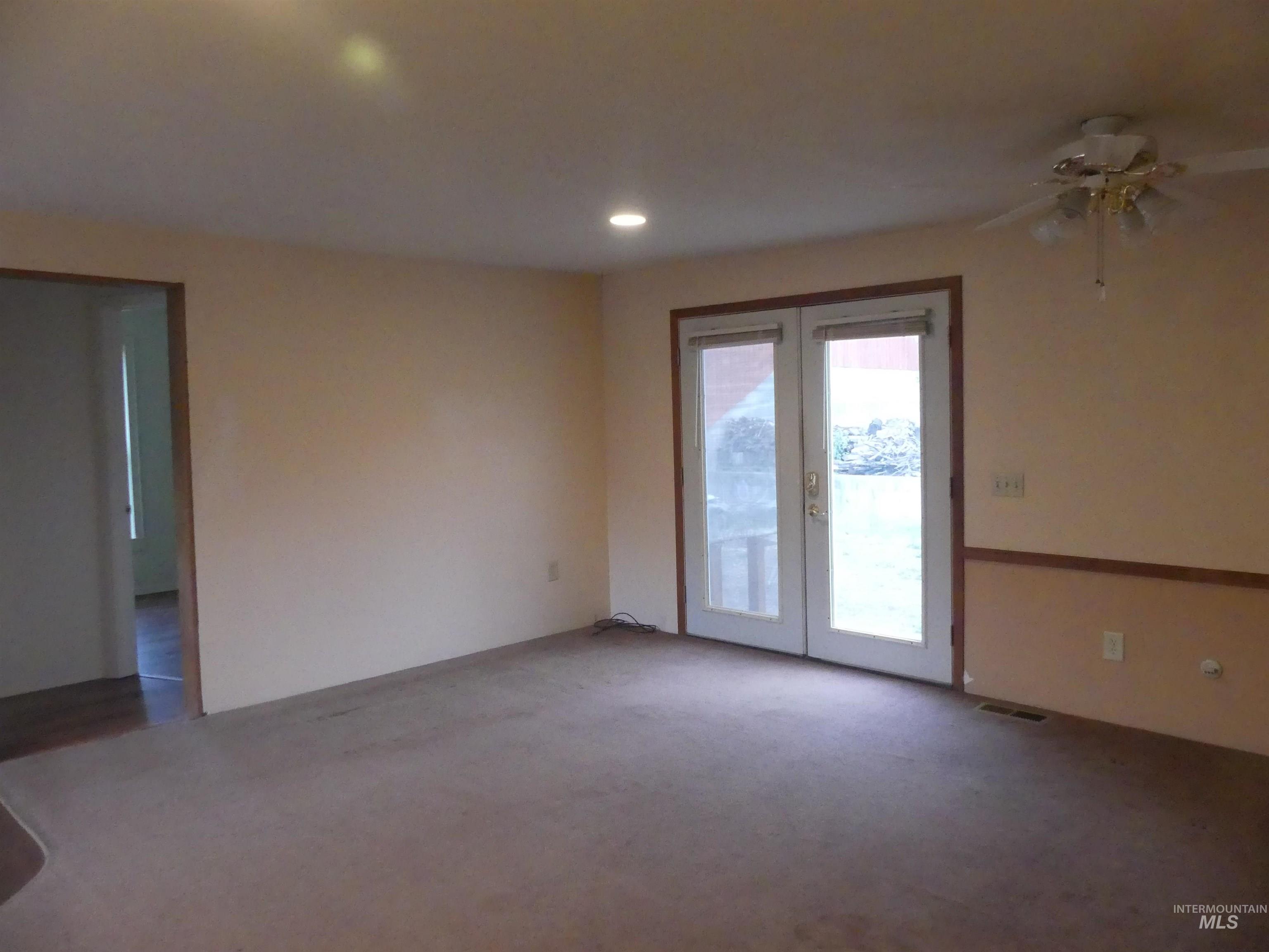 Carpeted spare room with french doors, recessed lighting, and ceiling fan