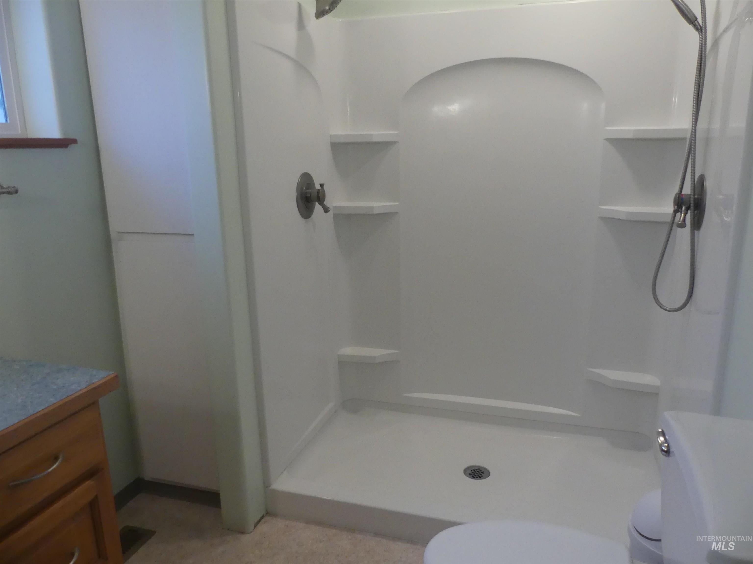 Full bathroom featuring vanity and a shower stall