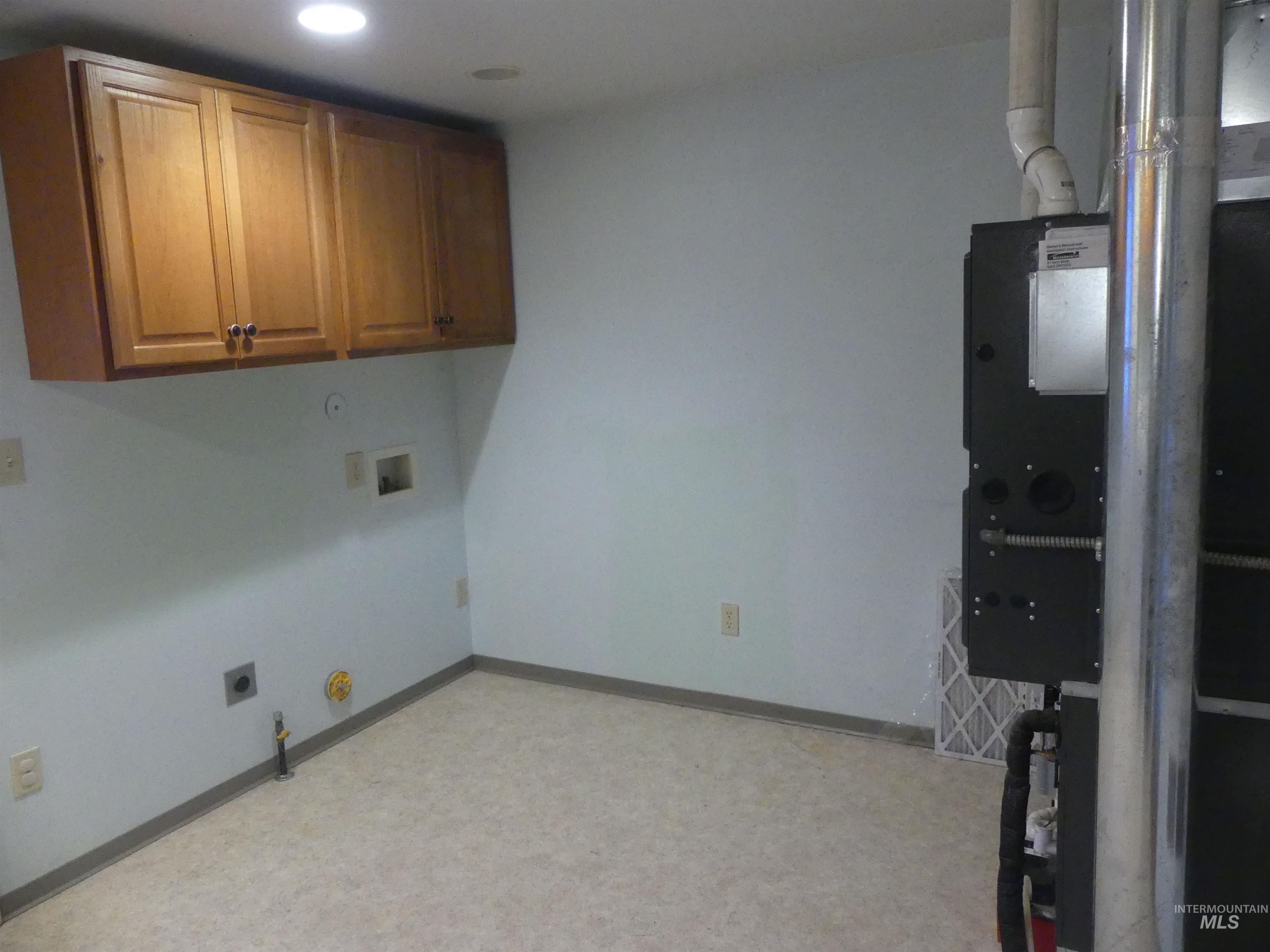 Laundry area featuring hookup for a gas dryer, heating unit, cabinet space, washer hookup, and recessed lighting