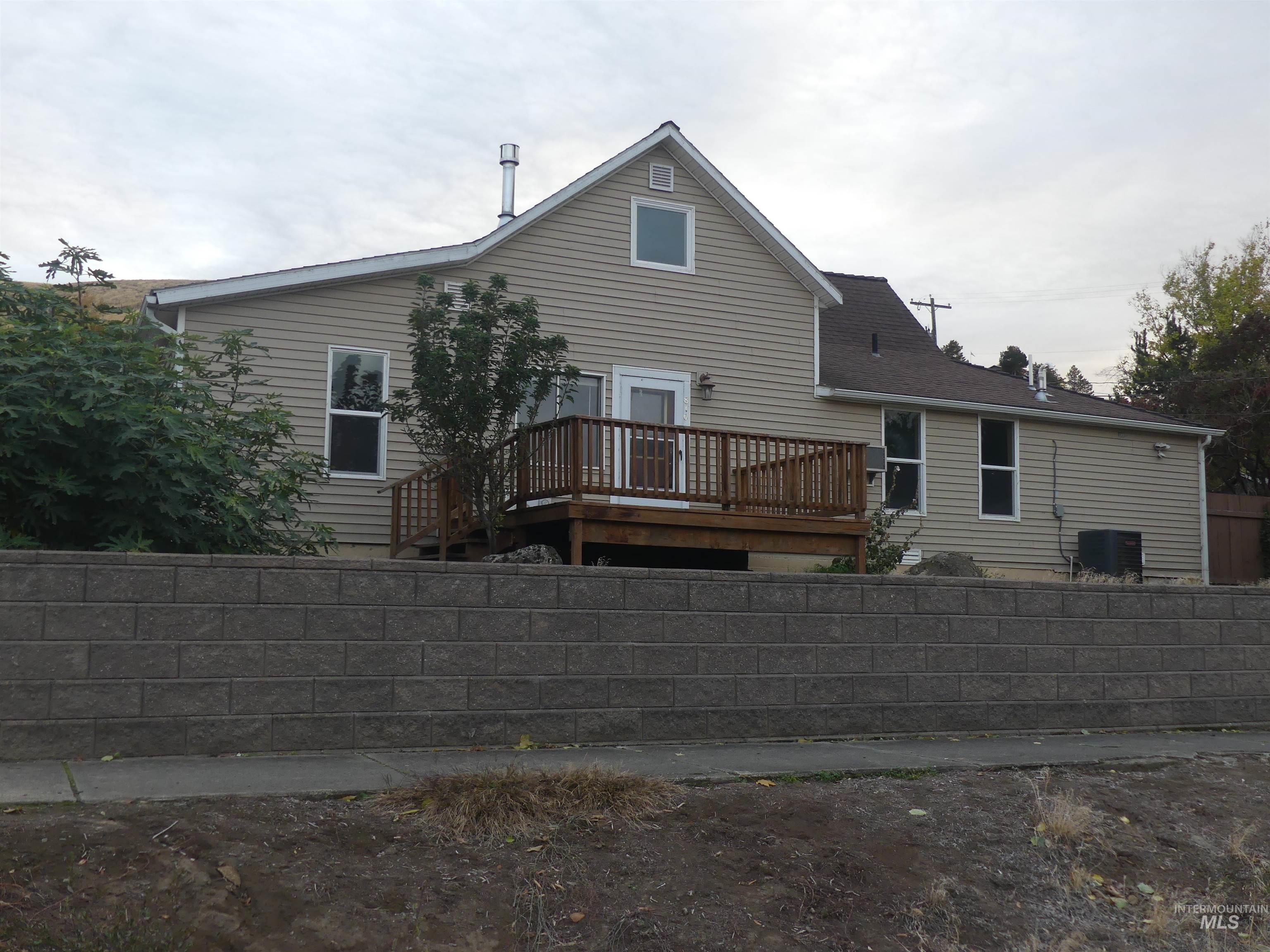 Back of house featuring a wooden deck