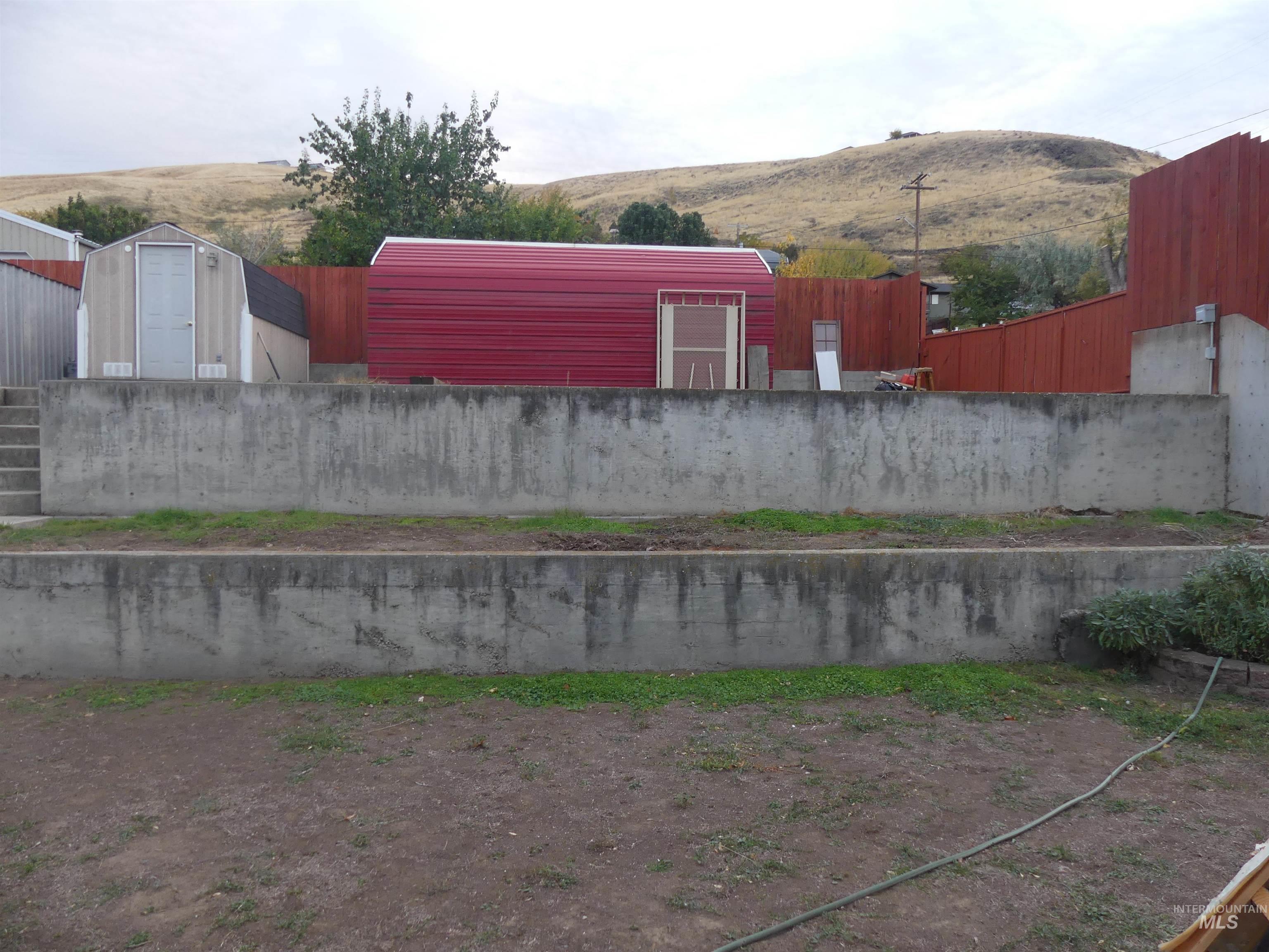 View of yard with a mountain view and a shed