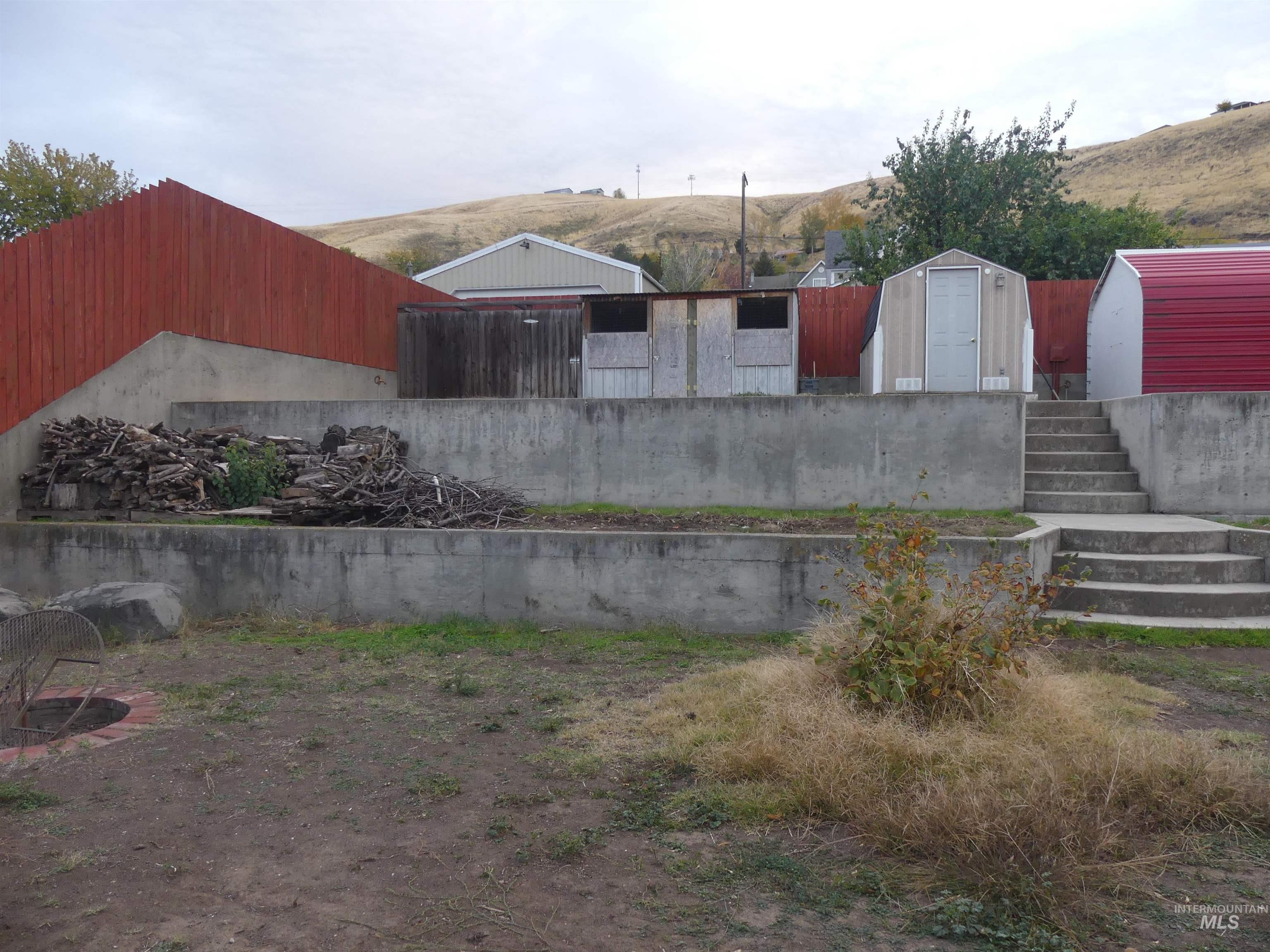 View of yard with a storage shed and stairs