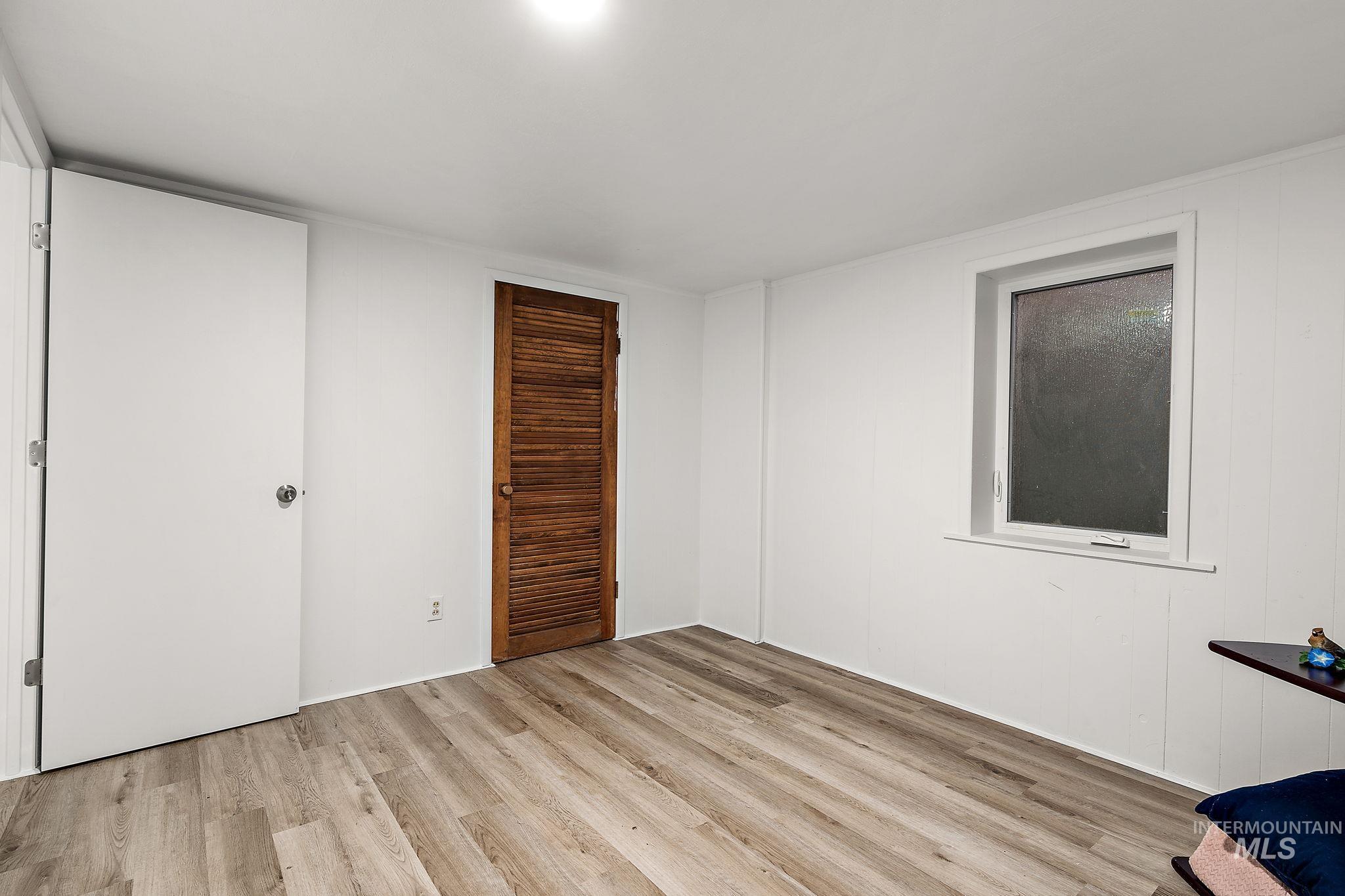 Unfurnished bedroom with light wood-type flooring and a closet