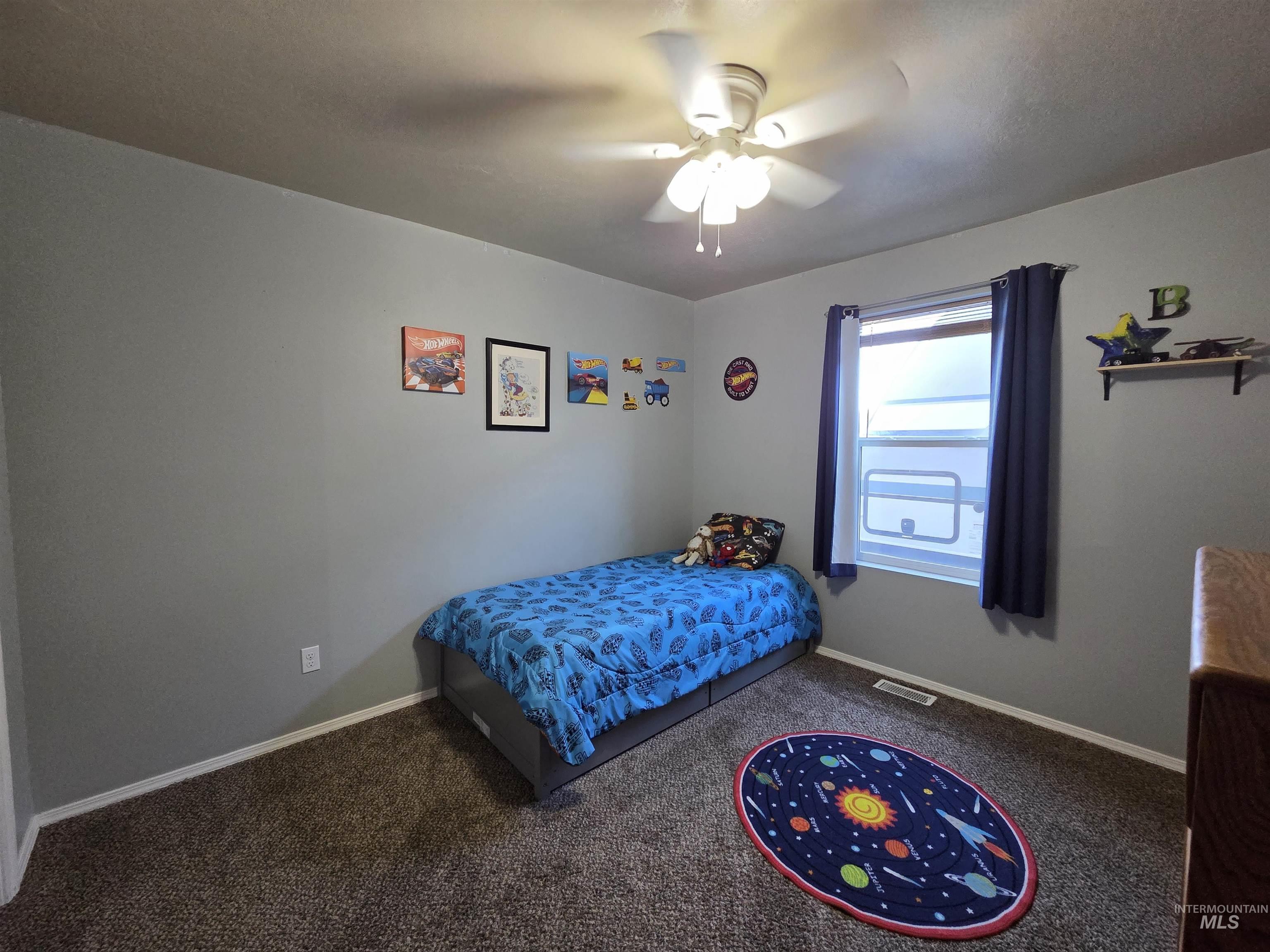 Bedroom with carpet flooring and a ceiling fan