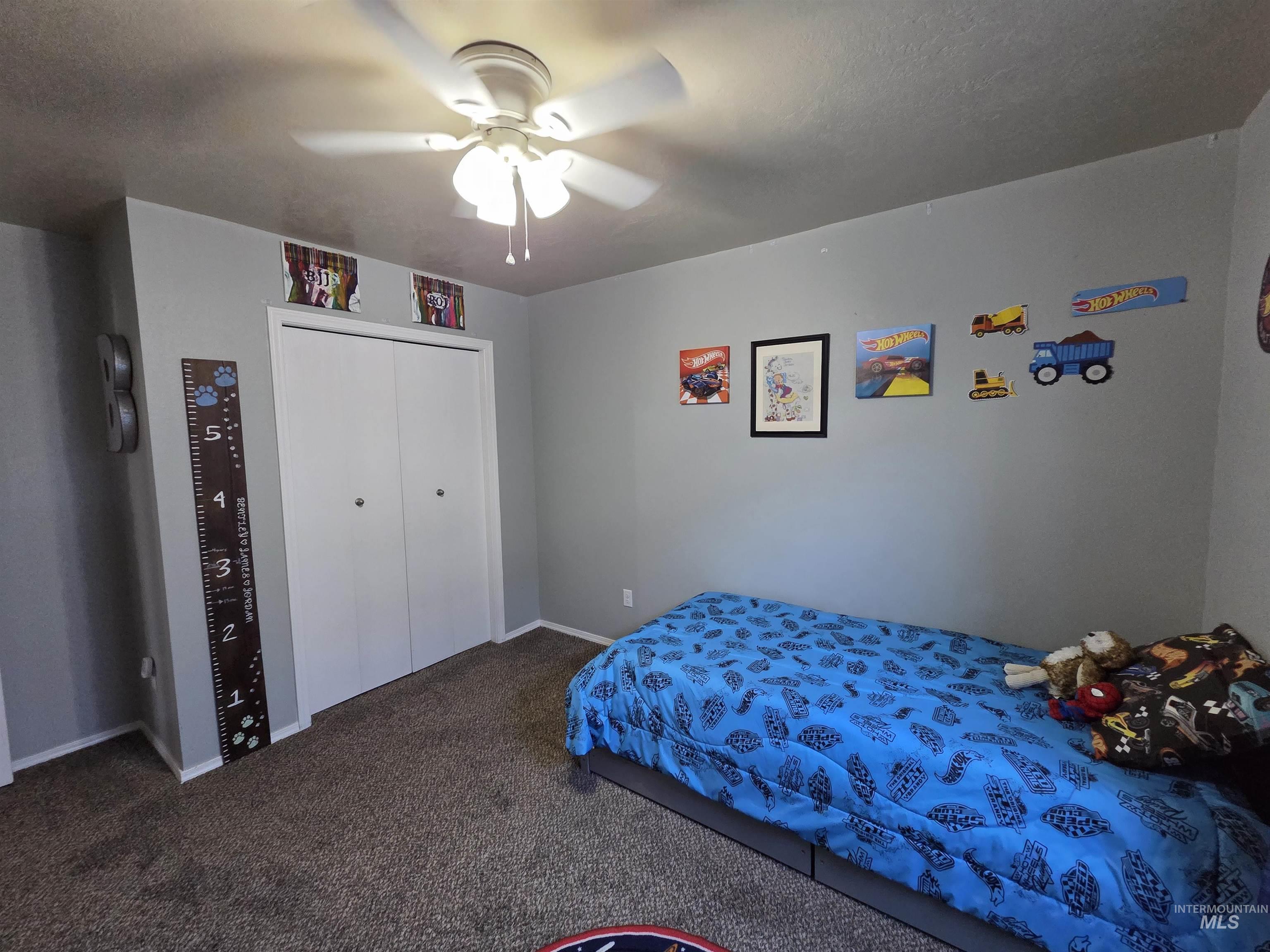 Bedroom with carpet, a closet, and ceiling fan