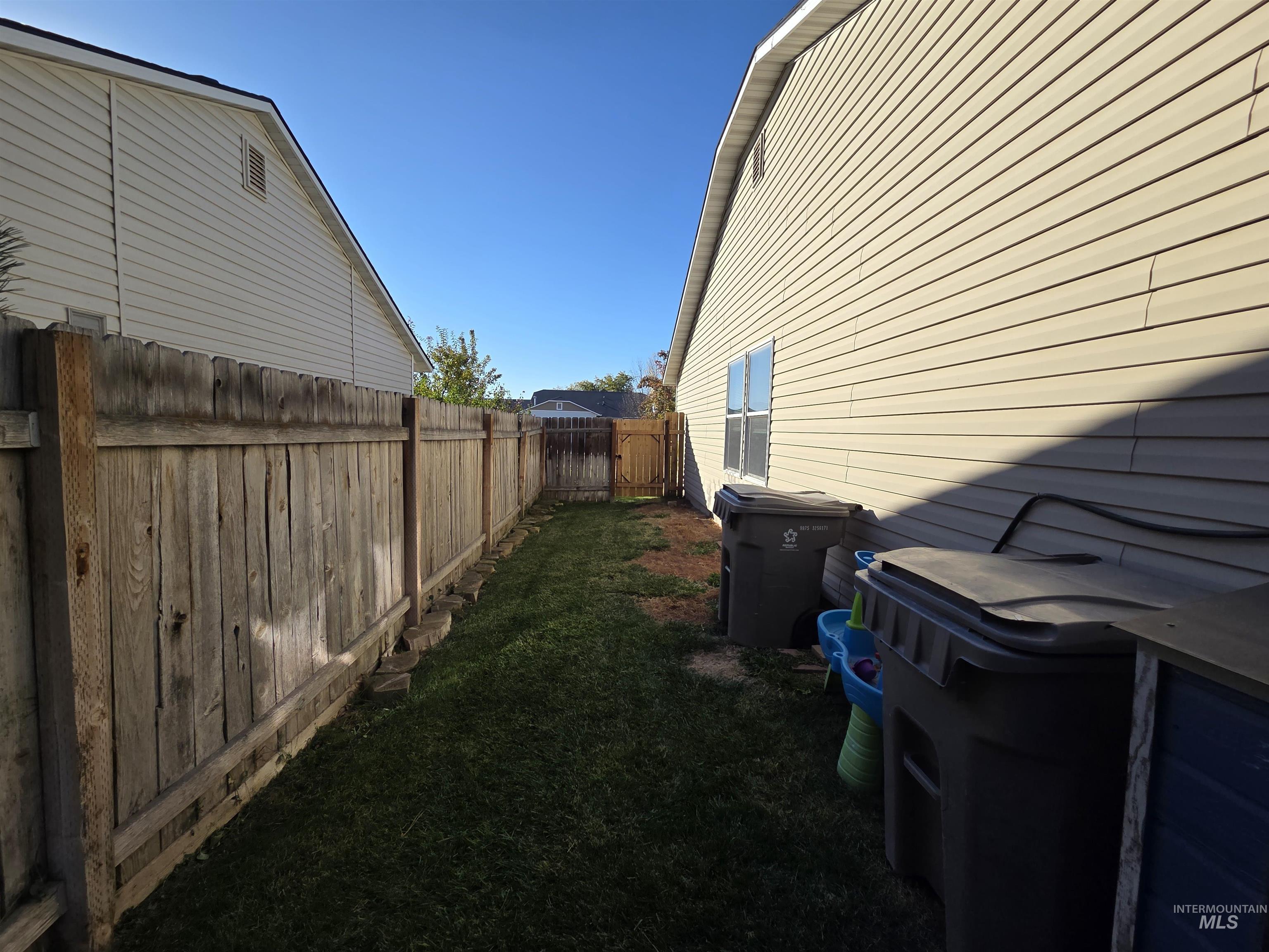View of property exterior featuring a fenced backyard