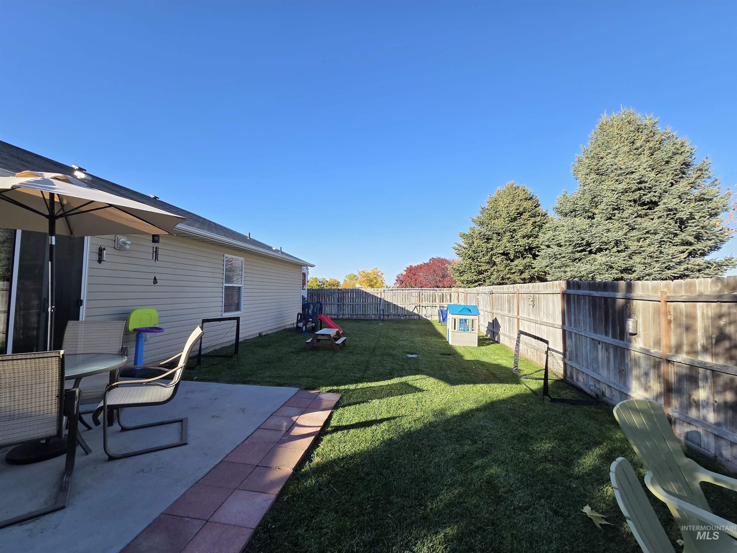 Fenced backyard featuring a patio