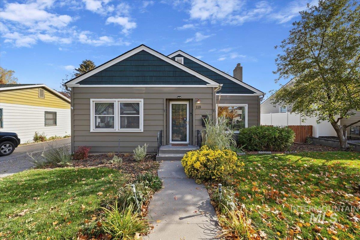 Bungalow-style house featuring a chimney
