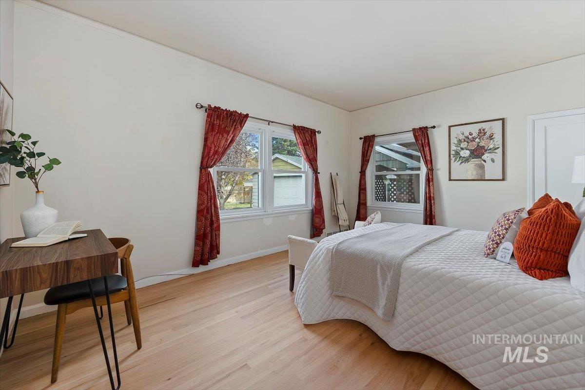 Bedroom featuring wood finished floors and baseboards