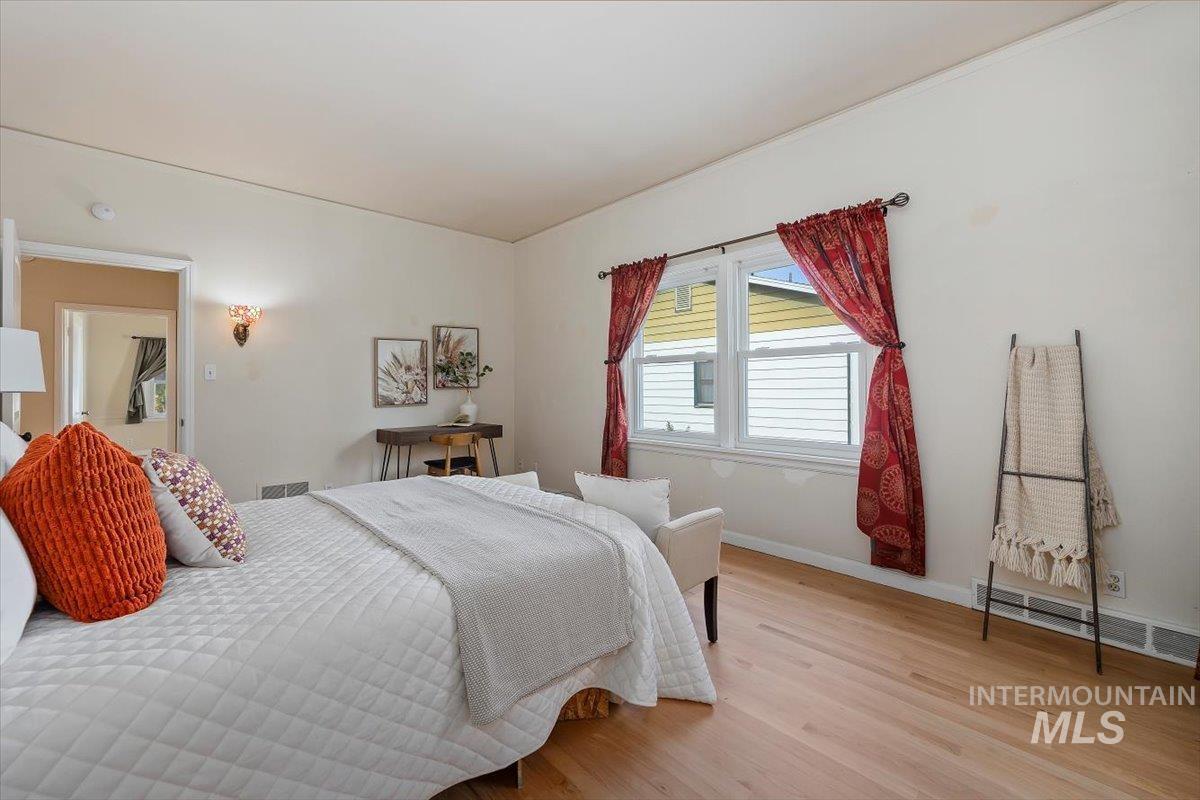 Bedroom with baseboards and light wood finished floors