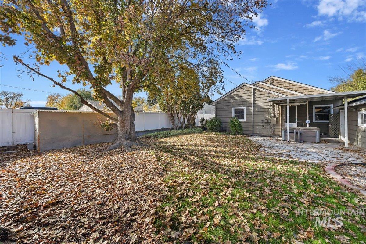 Rear view of property featuring a fenced backyard and a patio area
