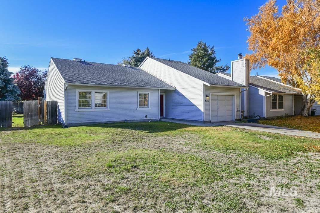Single story home with a garage, a shingled roof, driveway, and a chimney