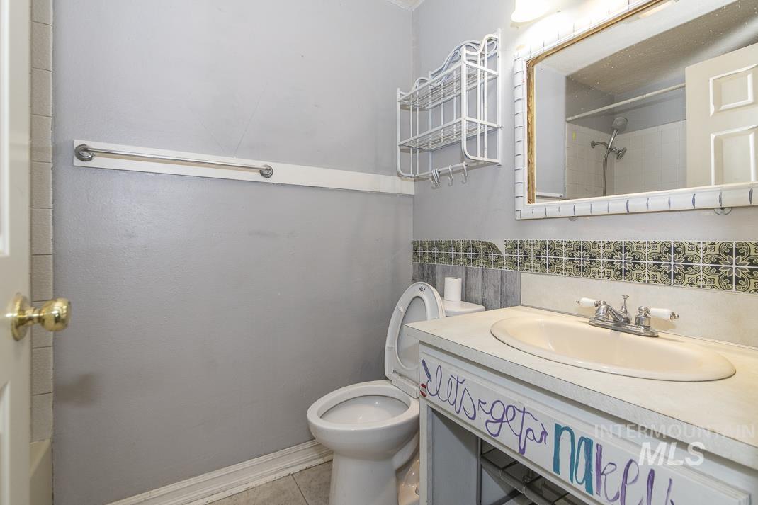 Bathroom featuring vanity and a shower