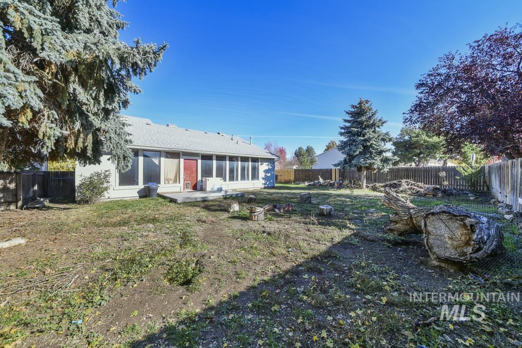 Back of property featuring a fenced backyard and a patio