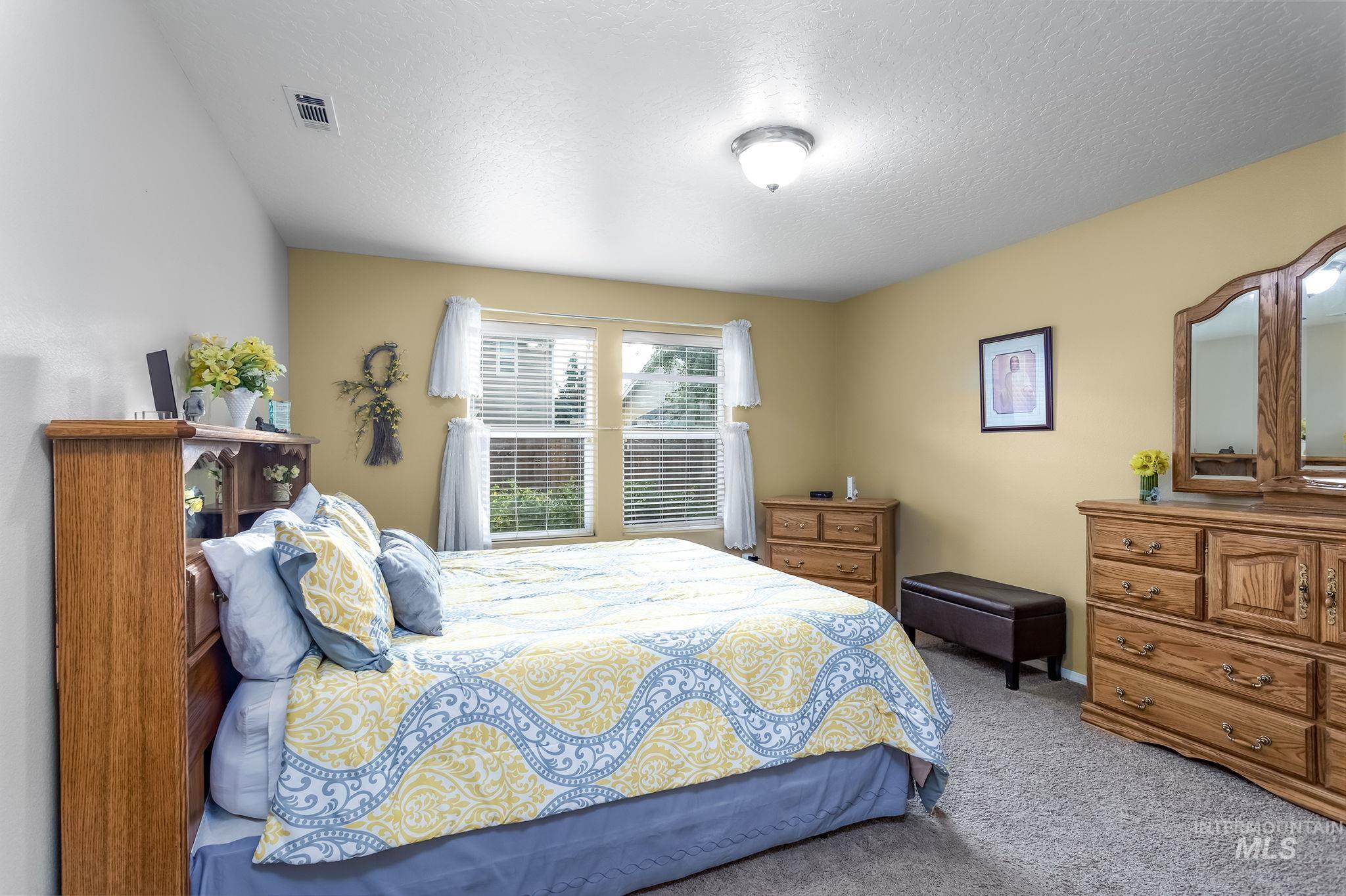 Bedroom with carpet floors and a textured ceiling
