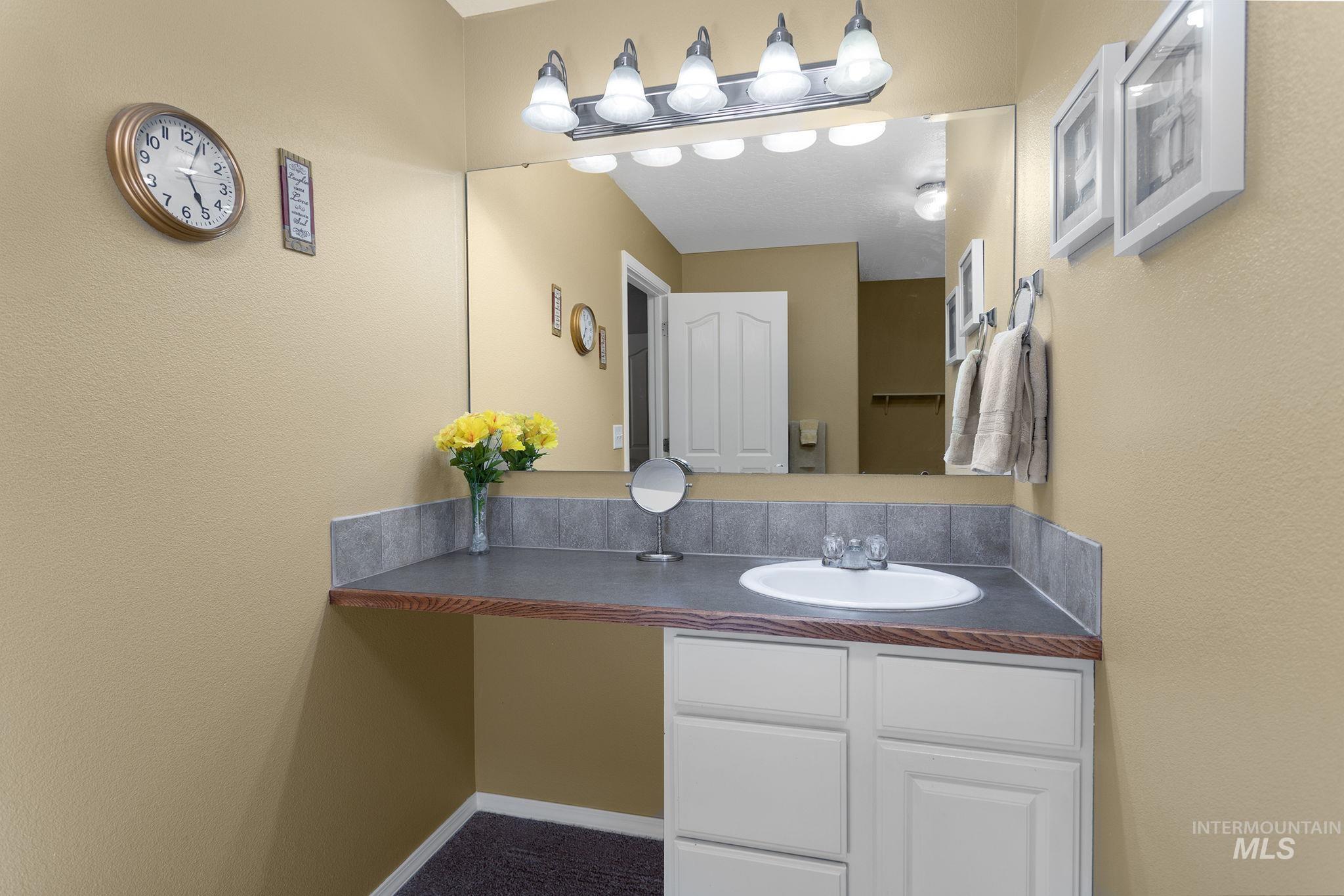 Bathroom featuring vanity and a textured wall