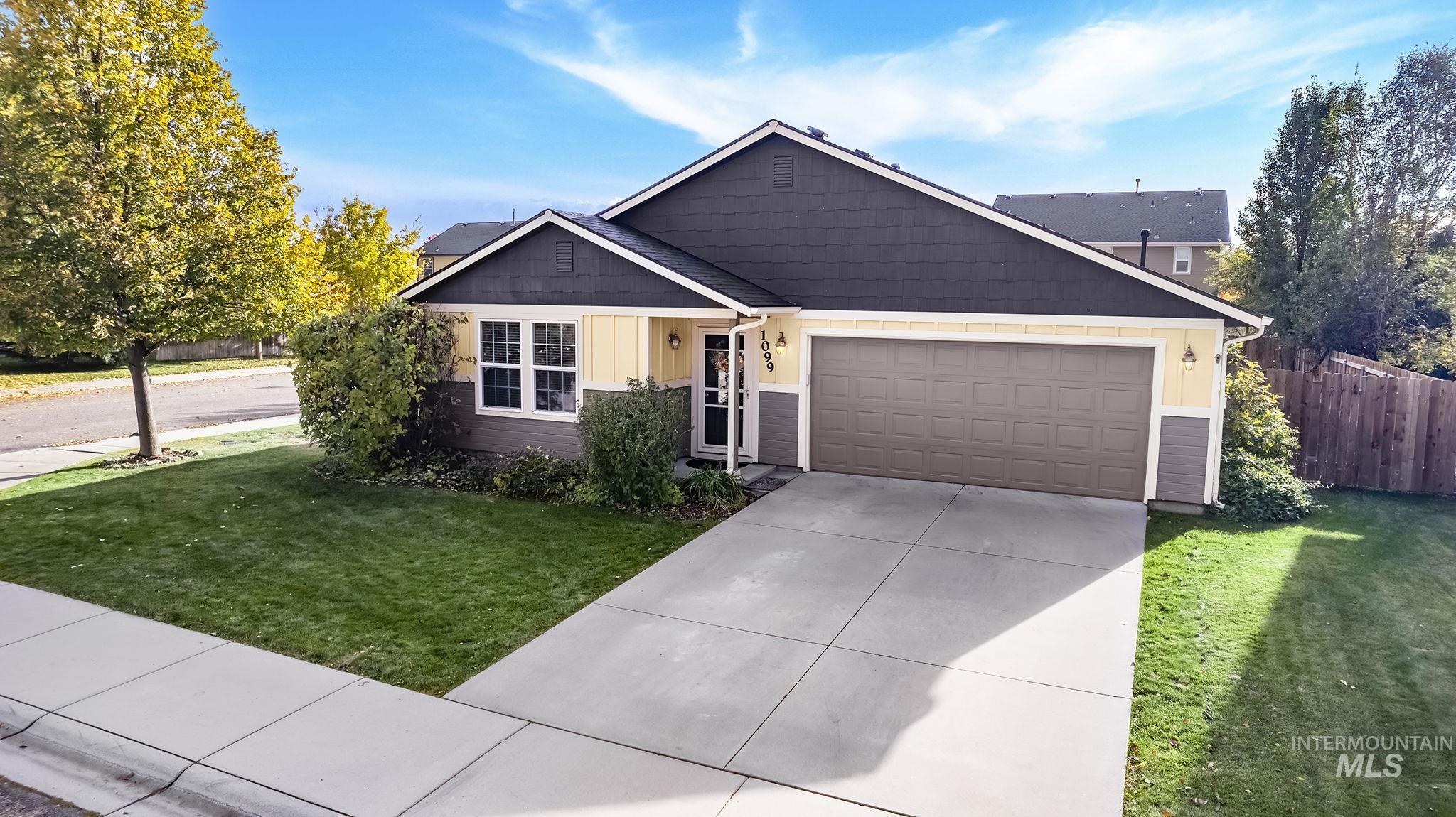 Ranch-style home with board and batten siding, concrete driveway, and a garage
