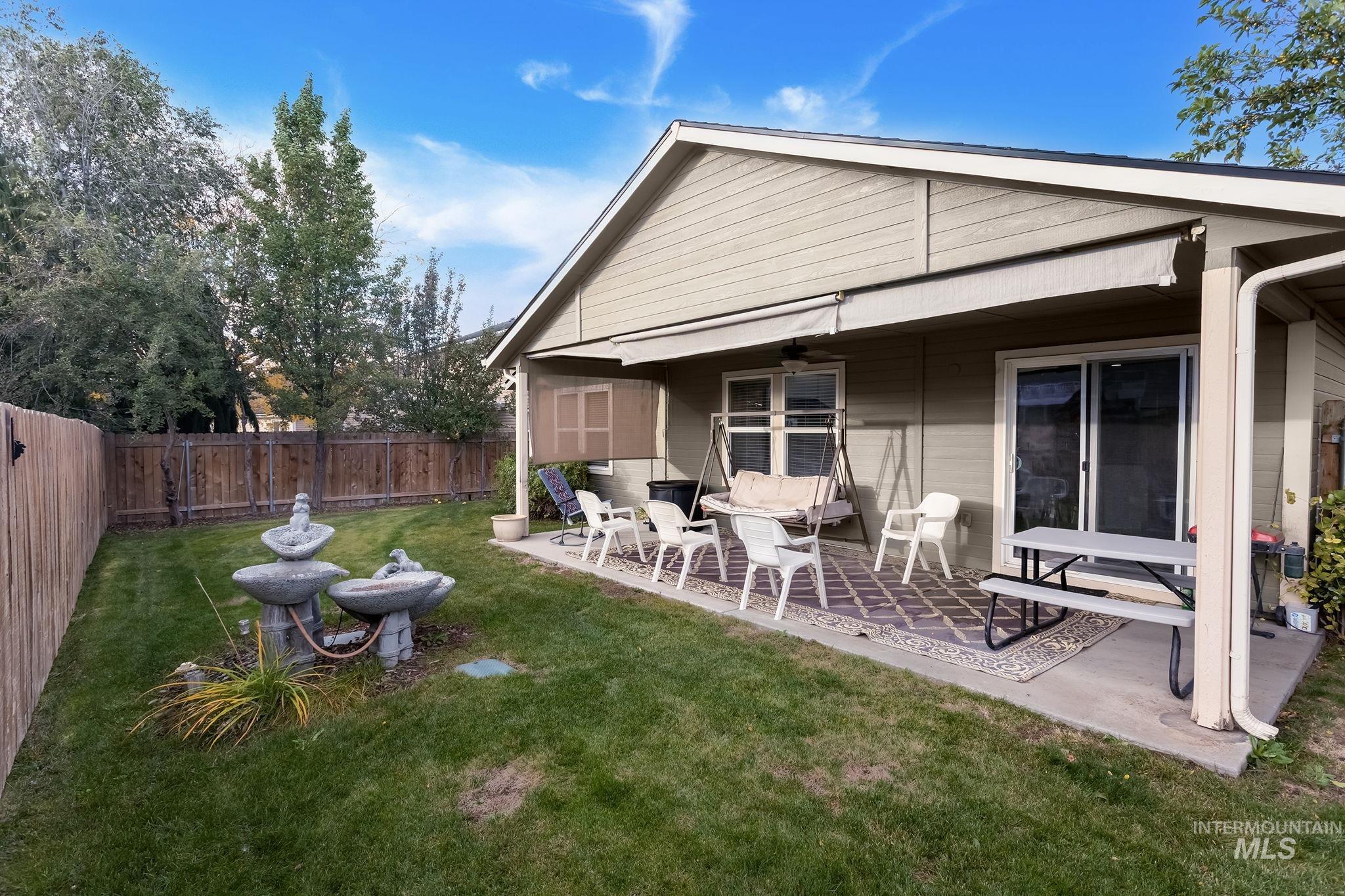 Back of house with a patio, a fenced backyard, and a ceiling fan
