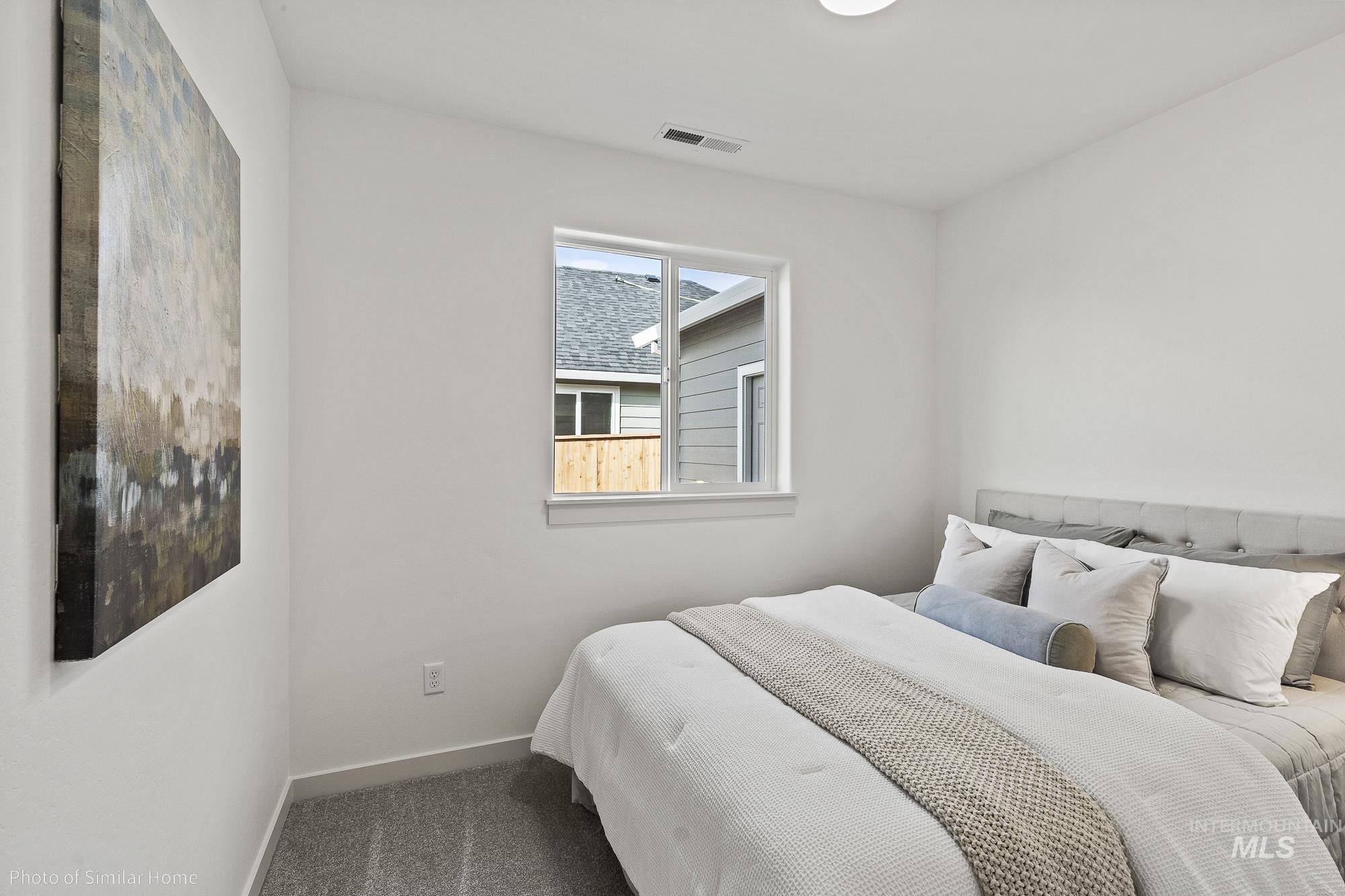 Carpeted bedroom with baseboards