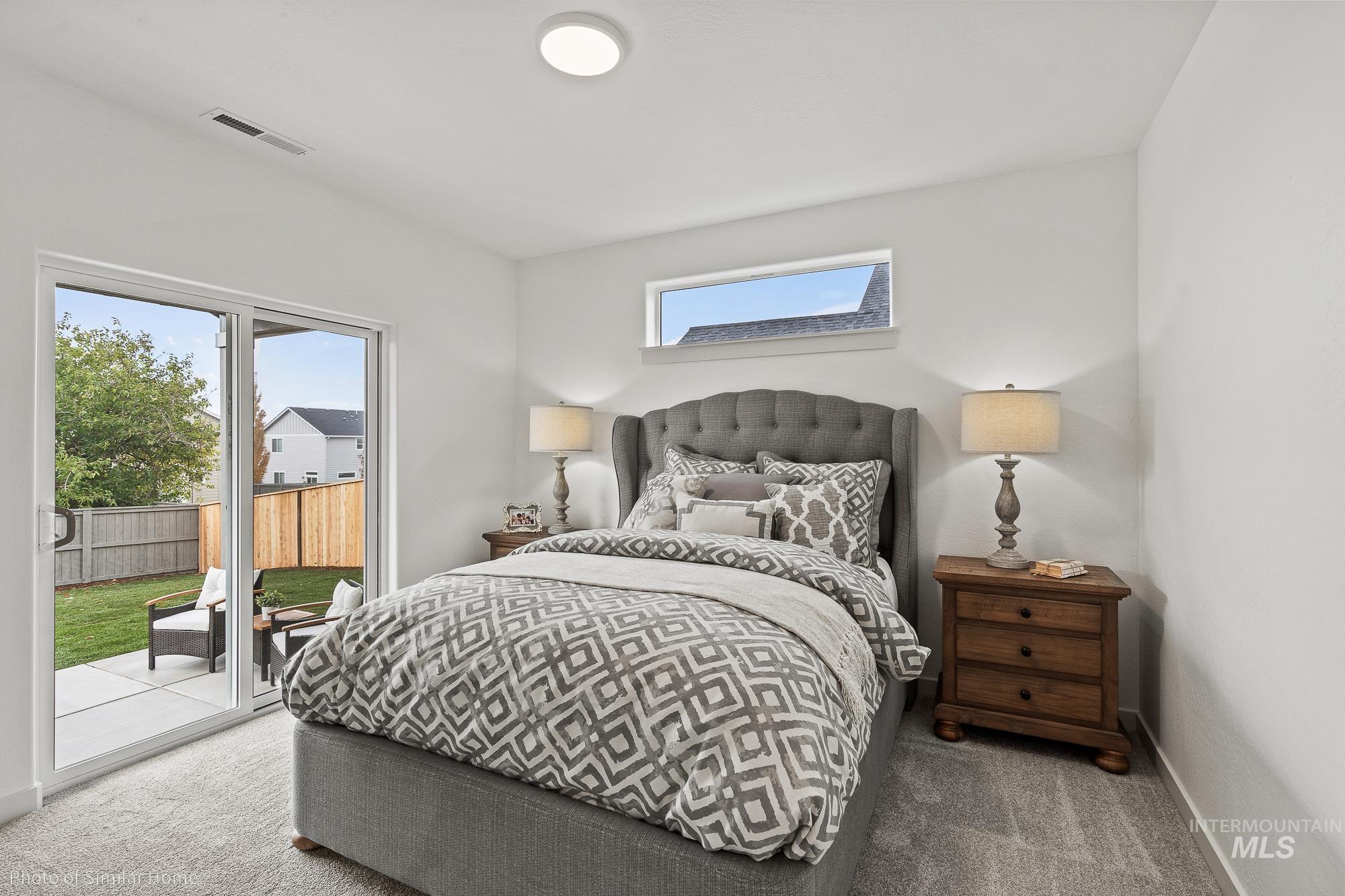 Bedroom featuring access to exterior, carpet flooring, and a skylight