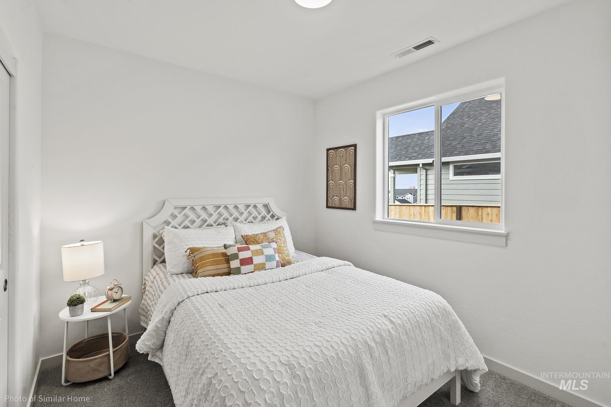 Carpeted bedroom featuring baseboards