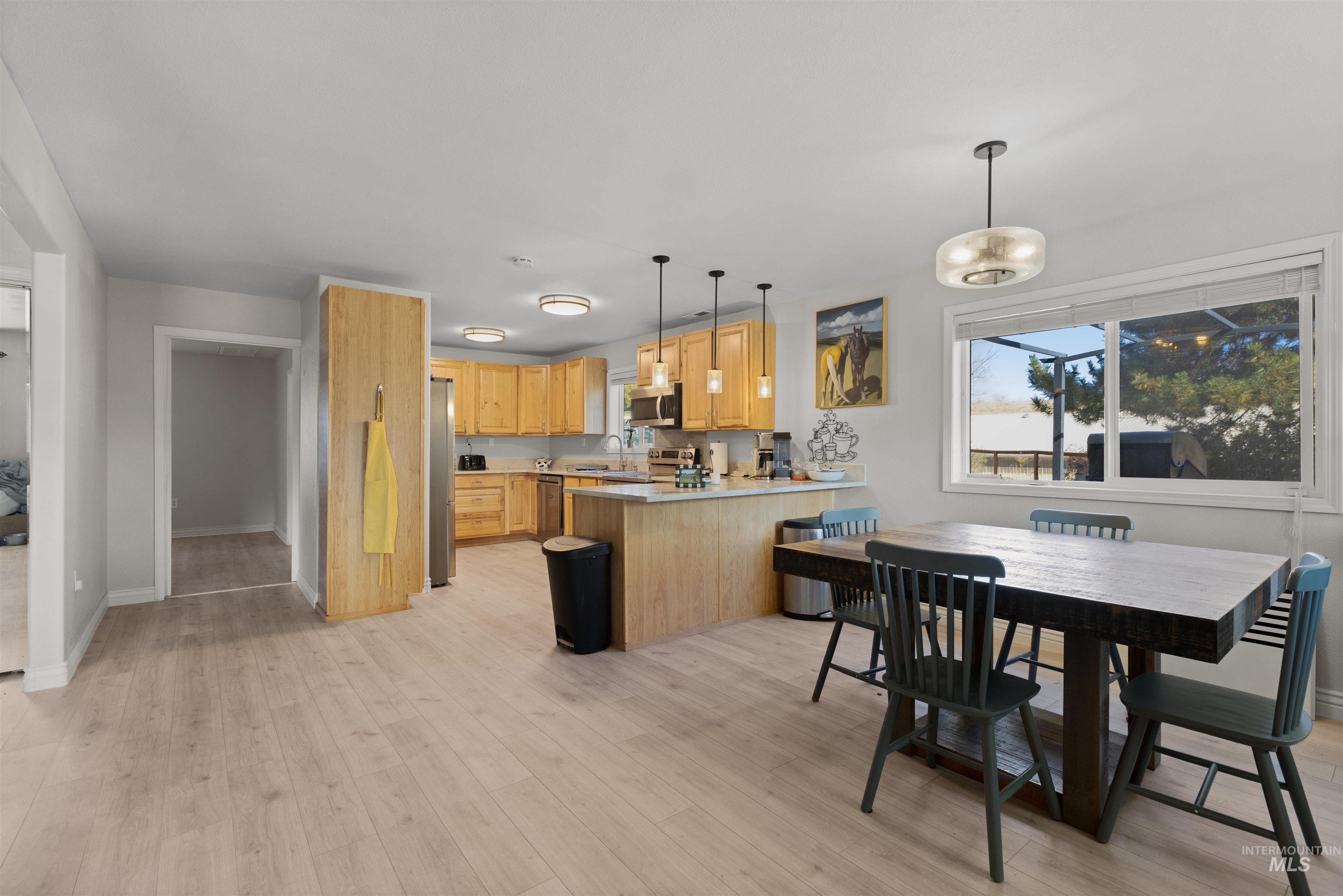 Dining space with baseboards and light wood-style flooring